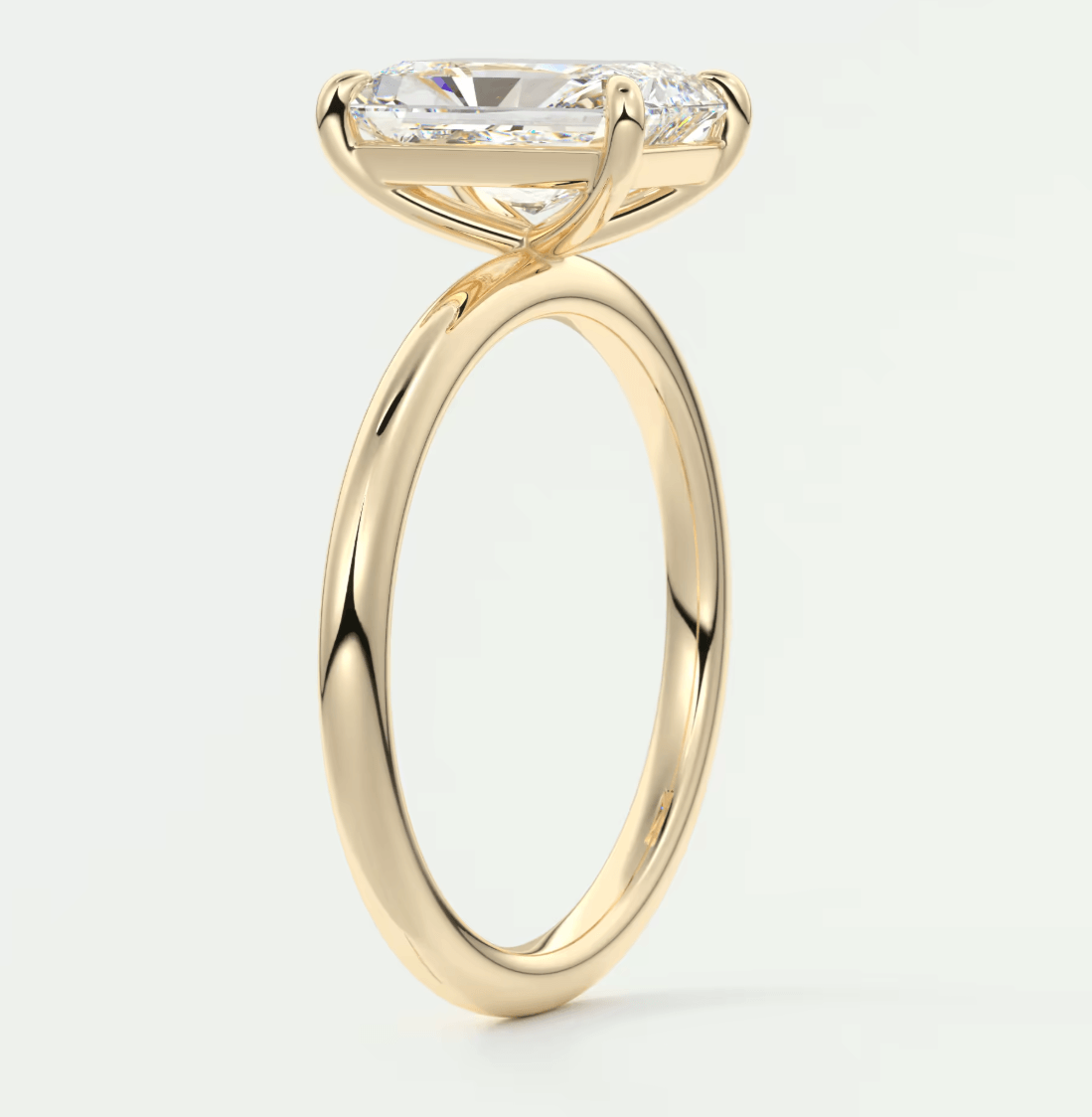 18k yellow gold engagement ring with a princess cut diamond.