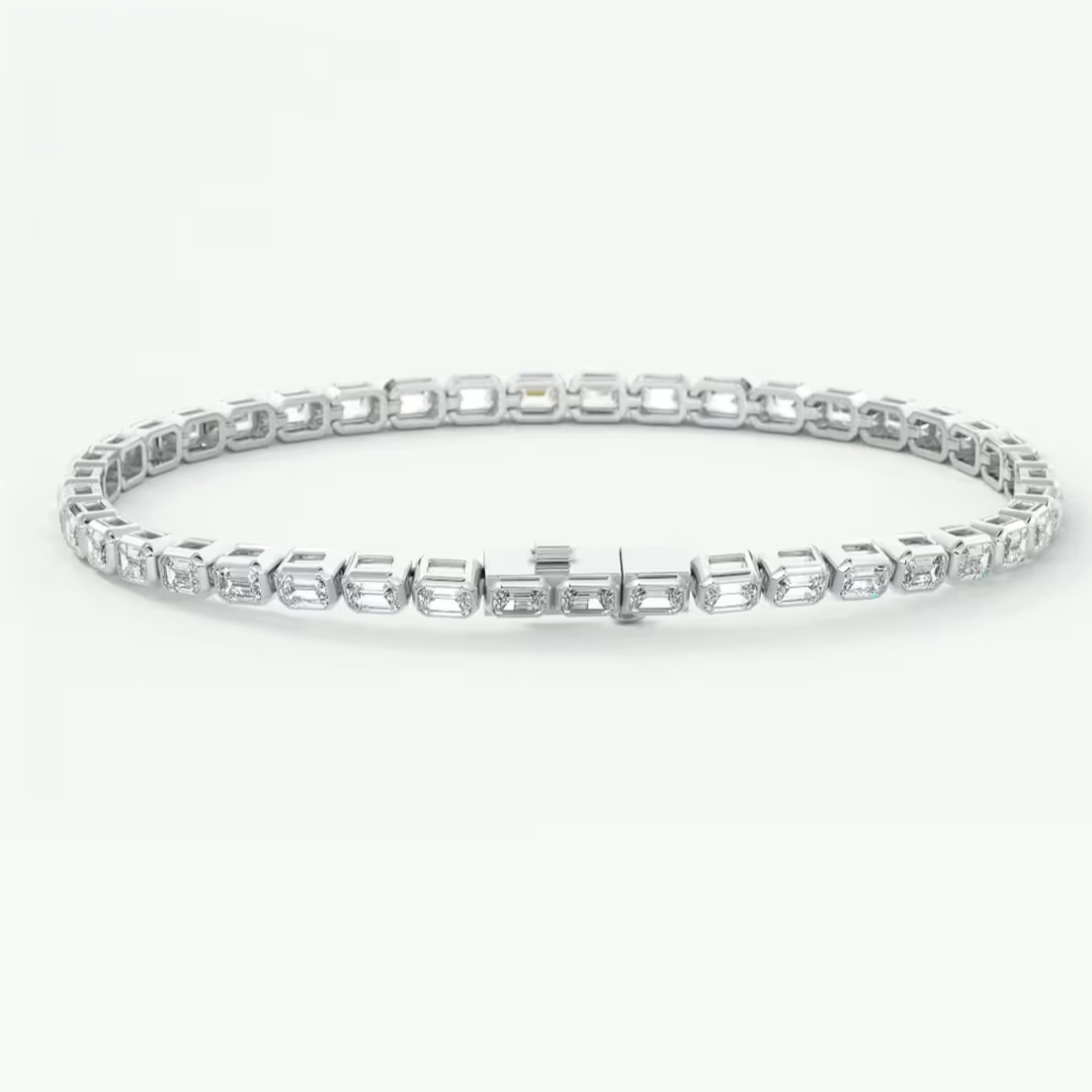 A platinum tennis bracelet with rectangular and baguette-cut clear stones, displayed in a circular shape on a clean white background.