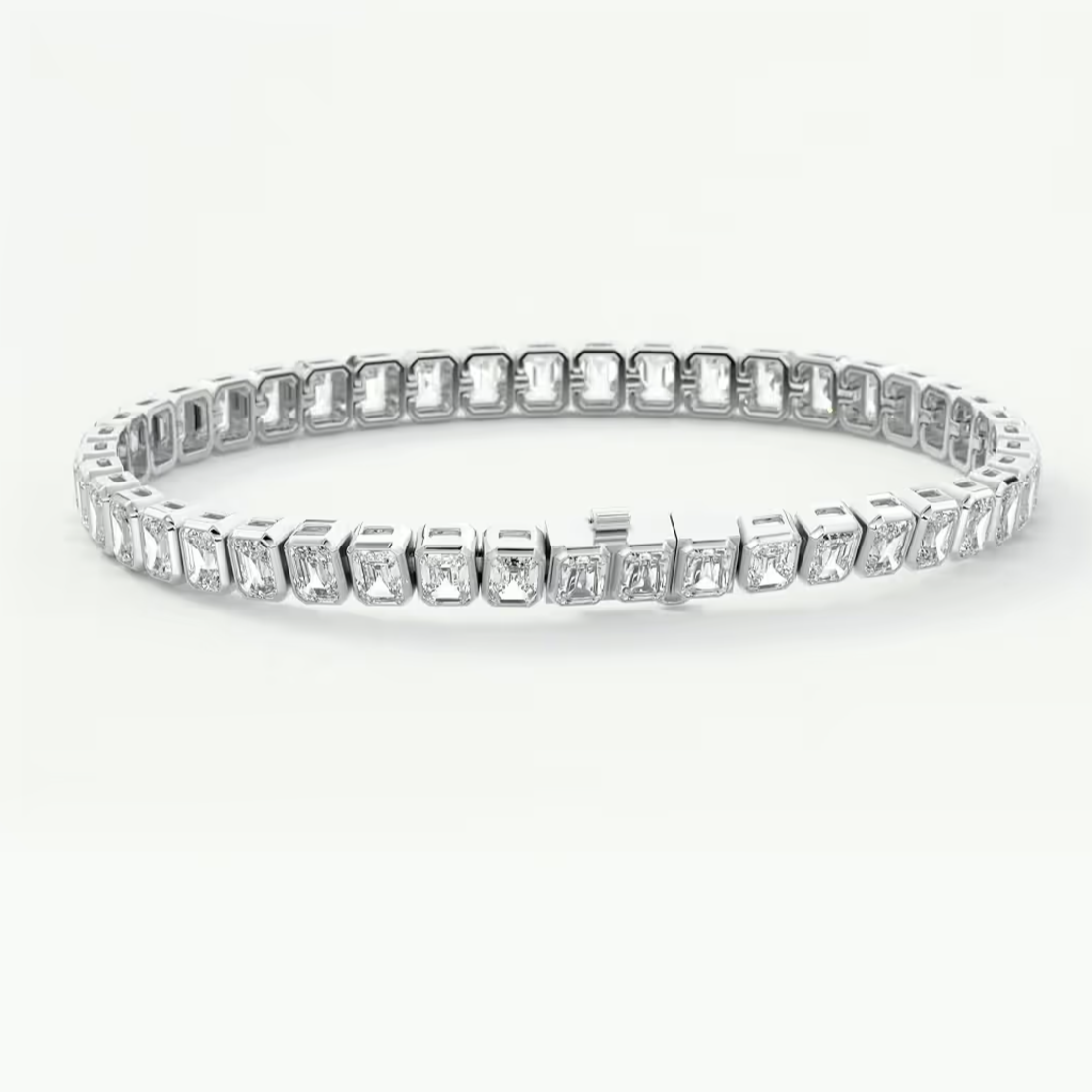 A platinum tennis bracelet featuring a continuous row of baguette-cut clear gemstones in a prong setting, displayed against a clean white background.