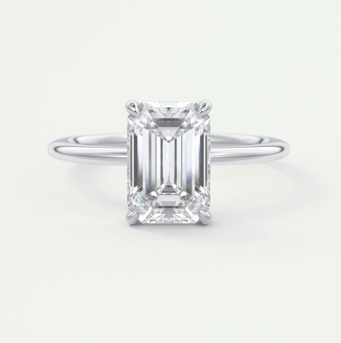 18-karat white gold emerald-cut diamond engagement ring.