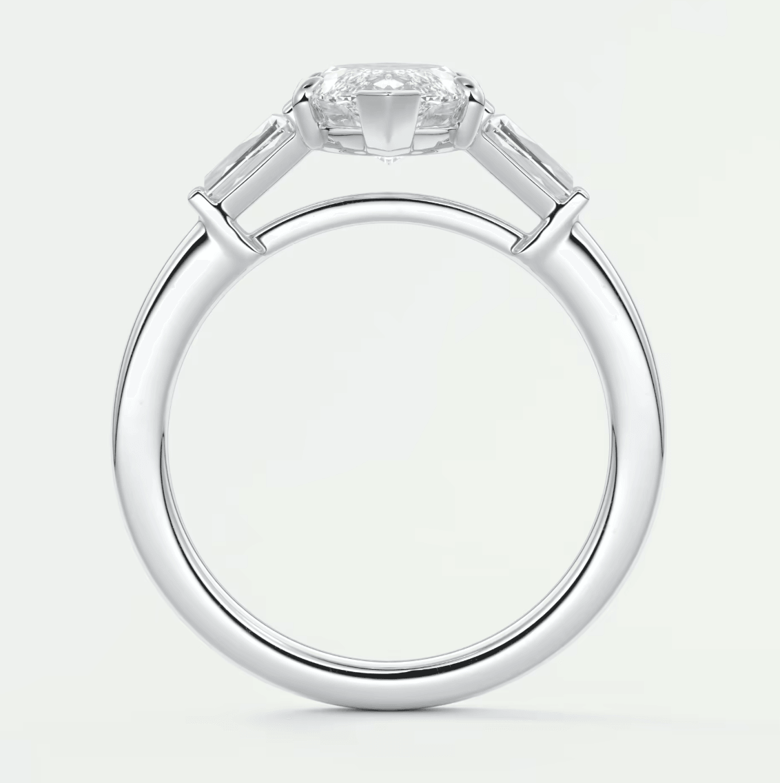 18k white gold engagement ring with a princess cut diamond and baguette side stones.