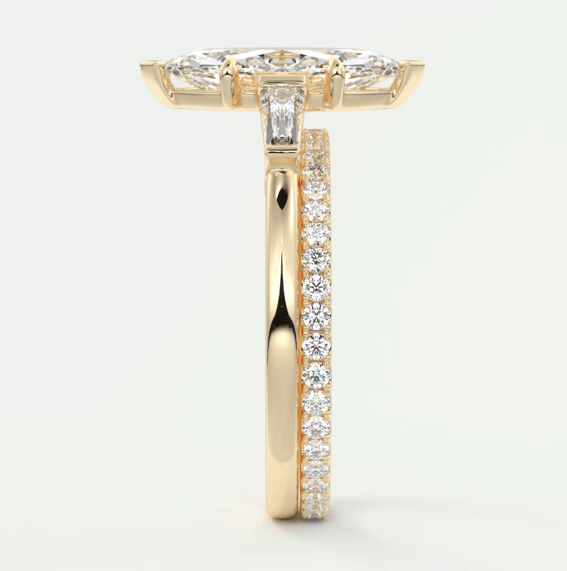 18k yellow gold diamond engagement ring with a marquise-shaped center stone and channel-set diamonds on the band.