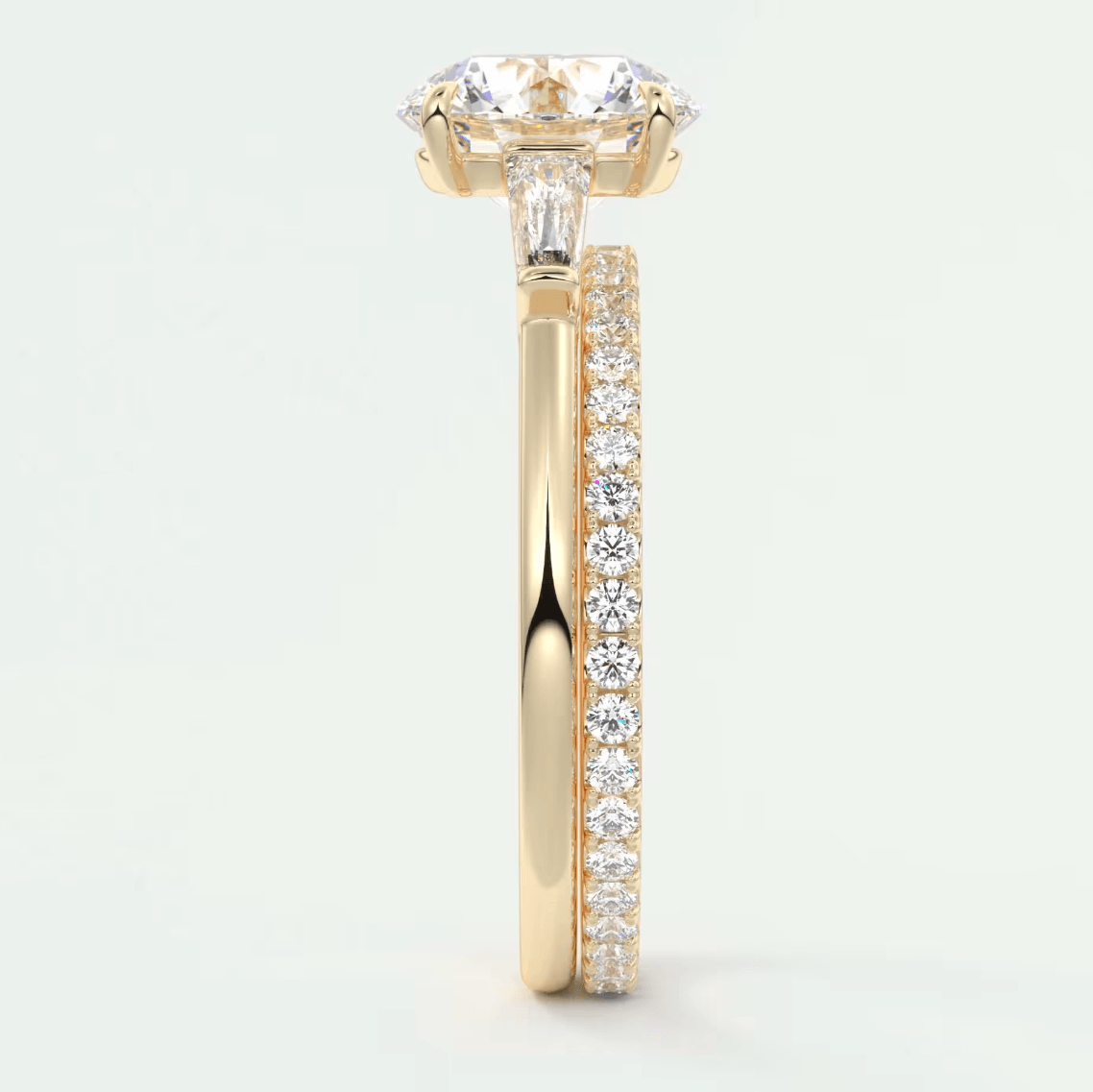 18k yellow gold engagement ring with a princess cut diamond and pavé side stones.