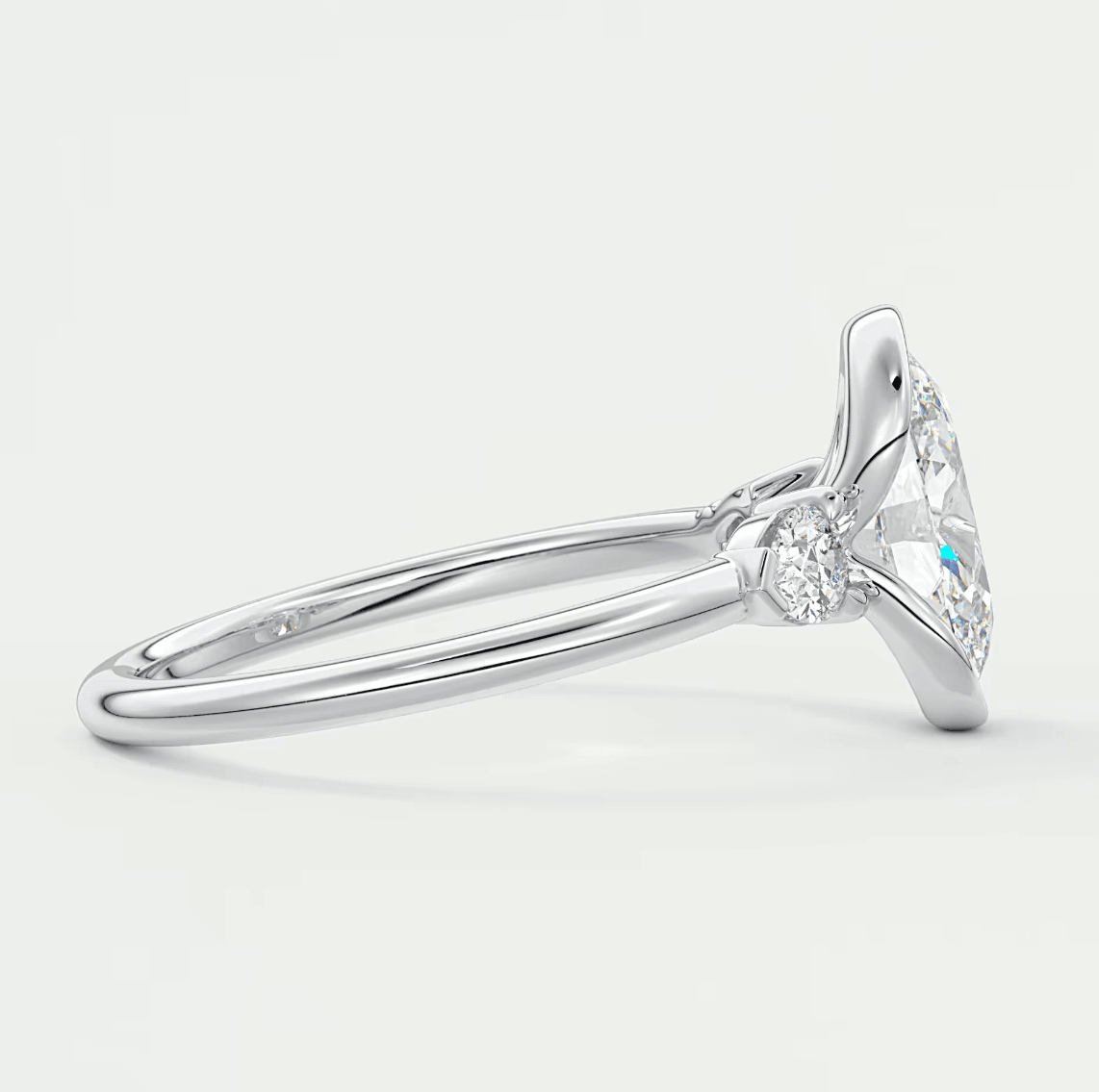18k white gold diamond engagement ring with a marquise-cut center stone and small diamonds on the band.