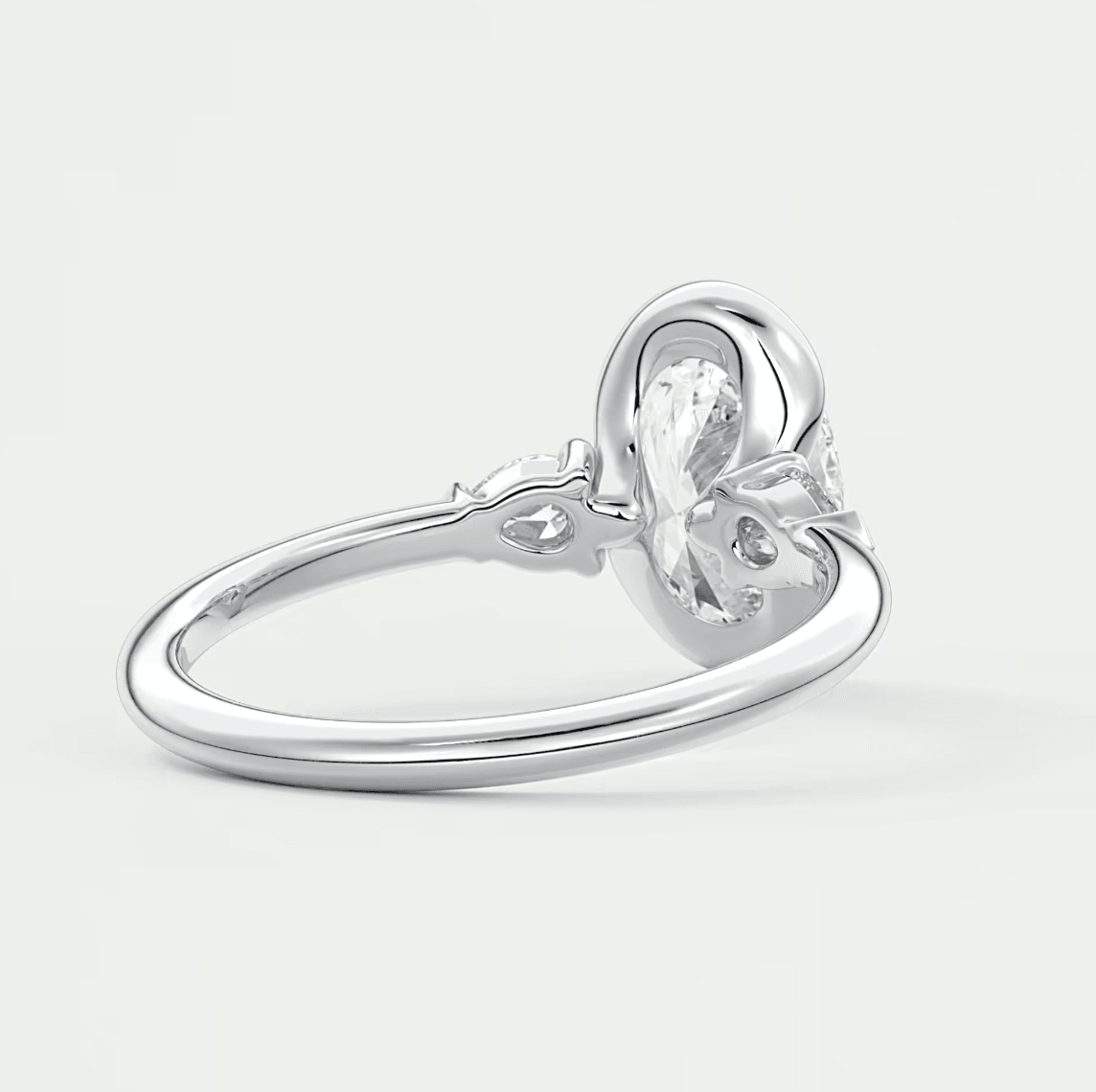 Silver knot engagement ring with a clear gemstone center.