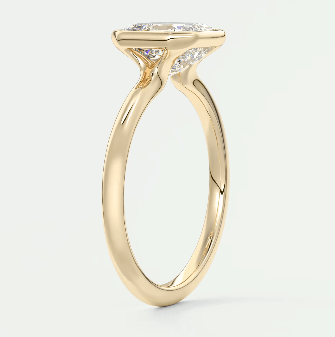 18-karat yellow gold engagement ring with a princess-cut diamond.