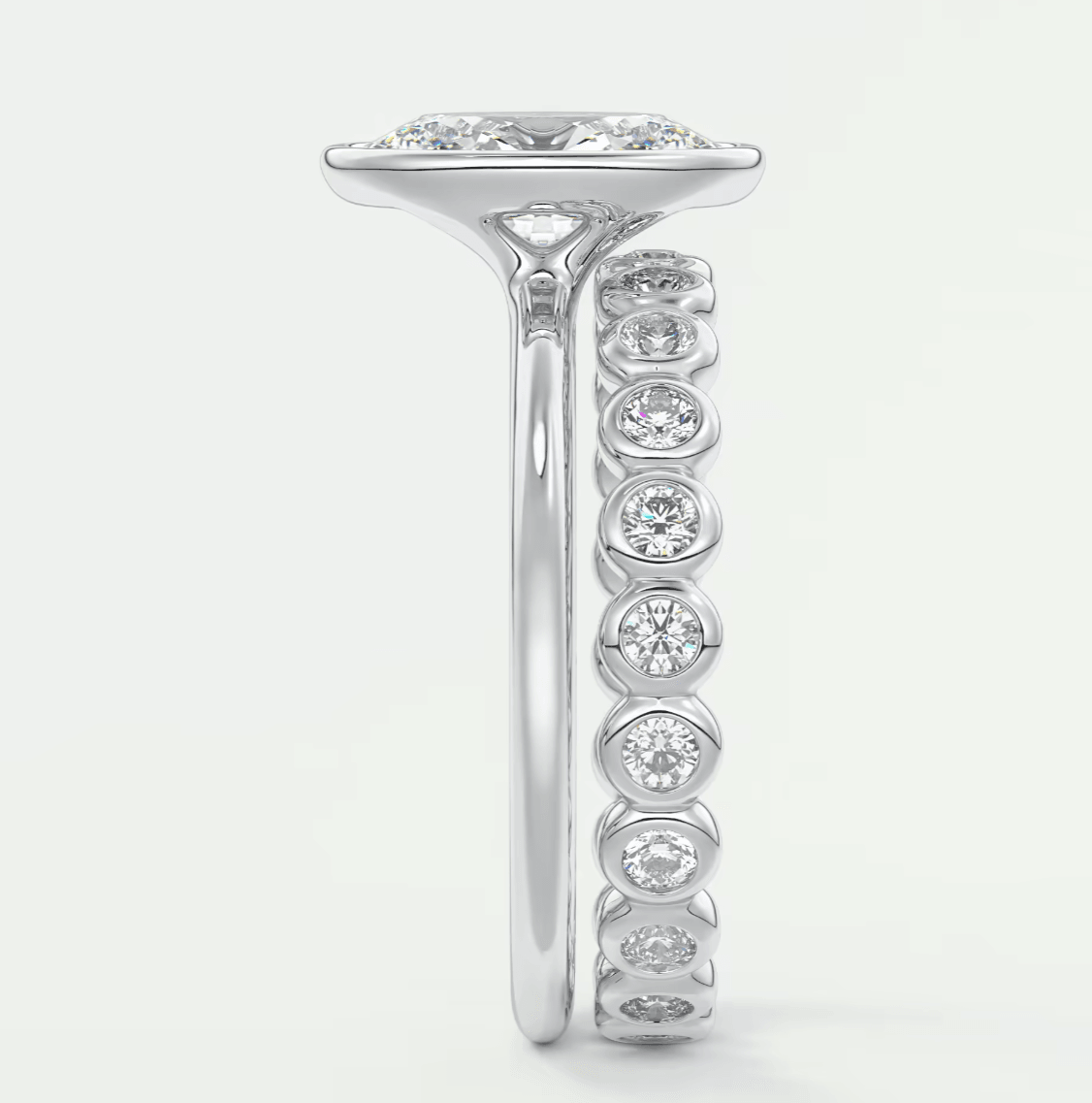 18k white gold diamond engagement ring with a princess cut center stone and channel set side stones.
