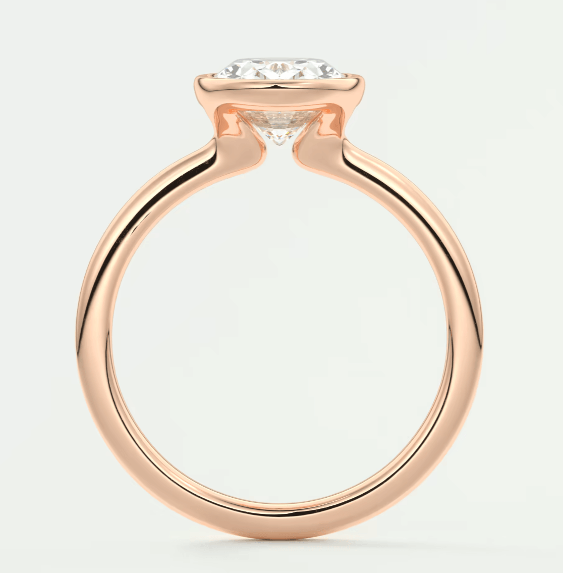 Rose gold engagement ring with a princess cut diamond center stone and milgrain detailing.
