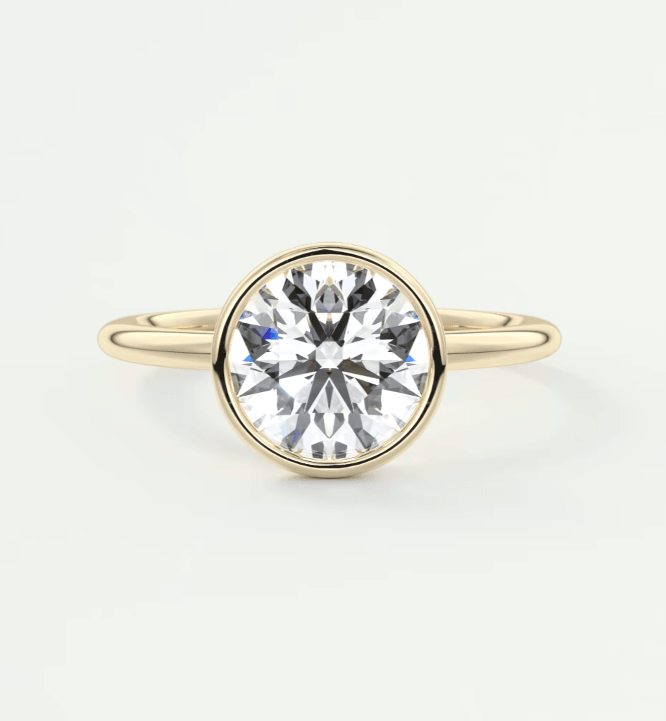 18k yellow gold solitaire diamond engagement ring with a bezel setting.