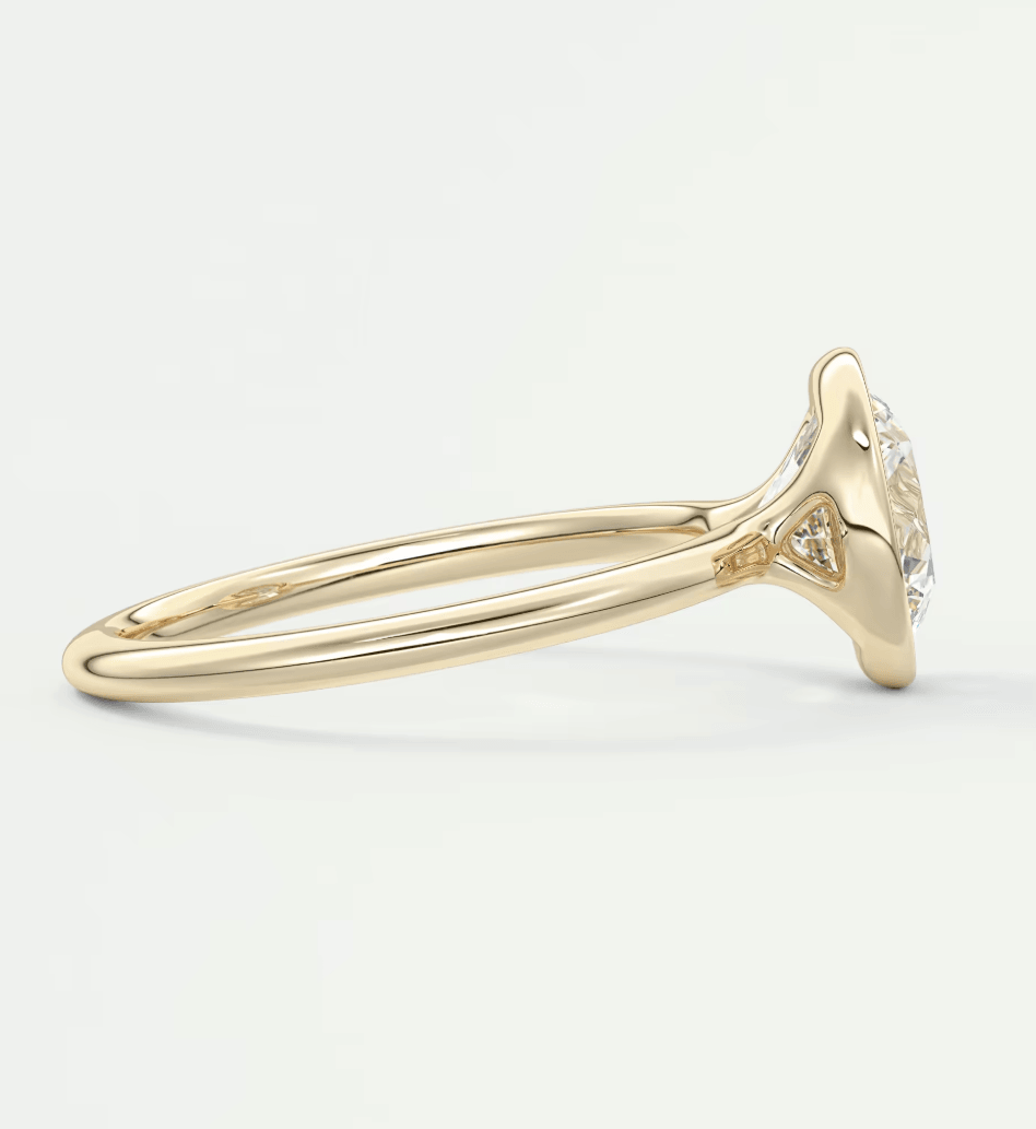 18k yellow gold diamond engagement ring with a round center stone and smaller diamonds on the band.