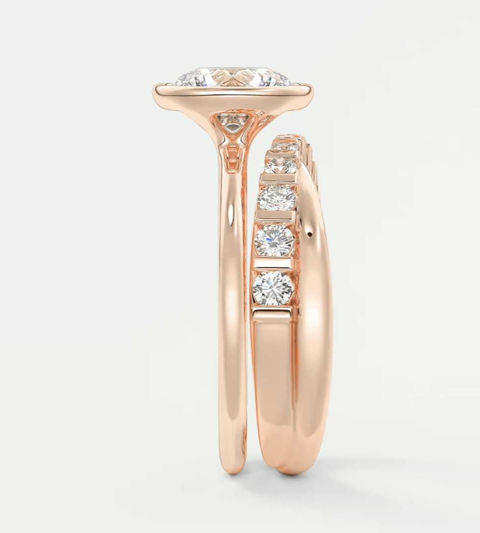18k rose gold diamond engagement ring with a cushion-cut center stone and three smaller diamonds on the band.