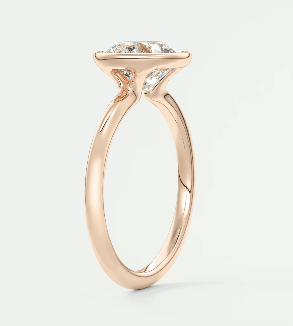 18-karat rose gold engagement ring with a round diamond.