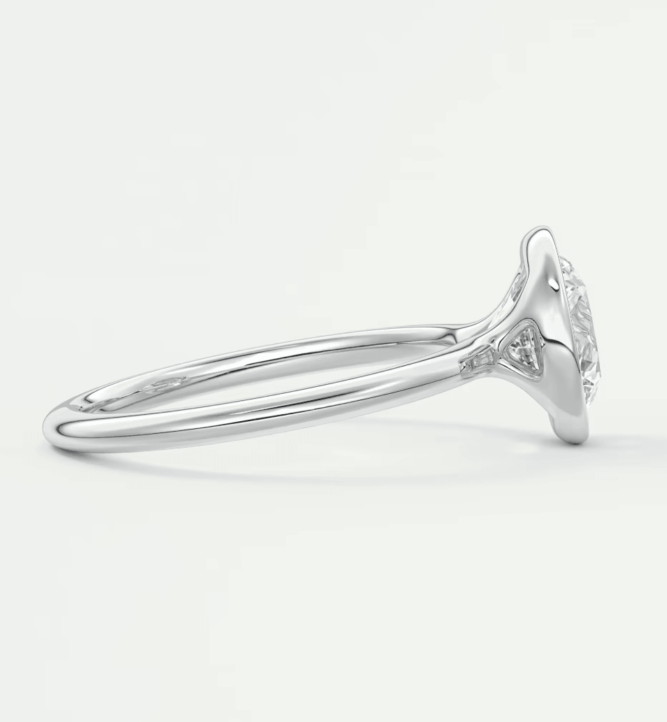 White gold diamond engagement ring with a round cut center stone and delicate band design.