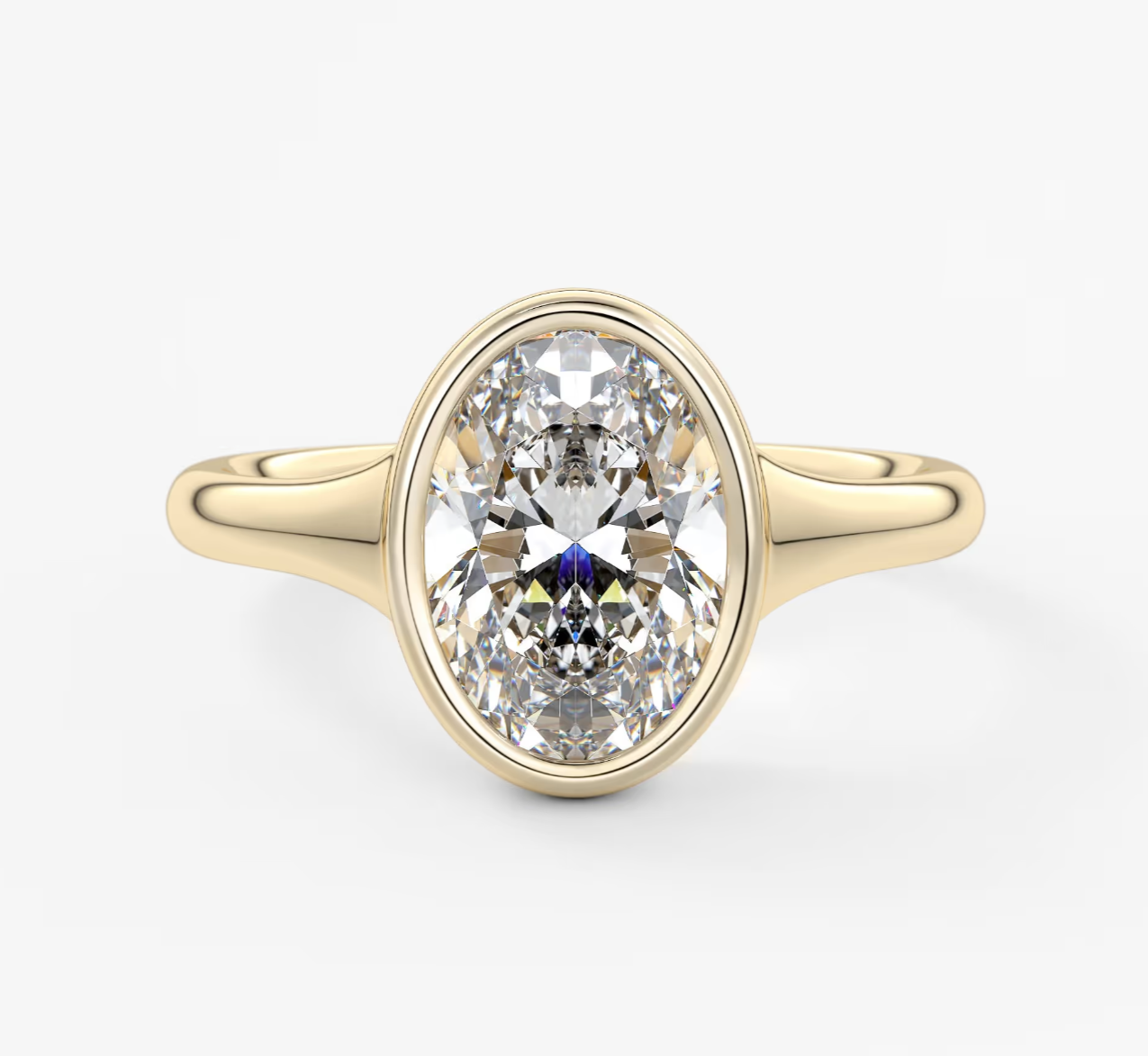 18-karat yellow gold oval diamond engagement ring.