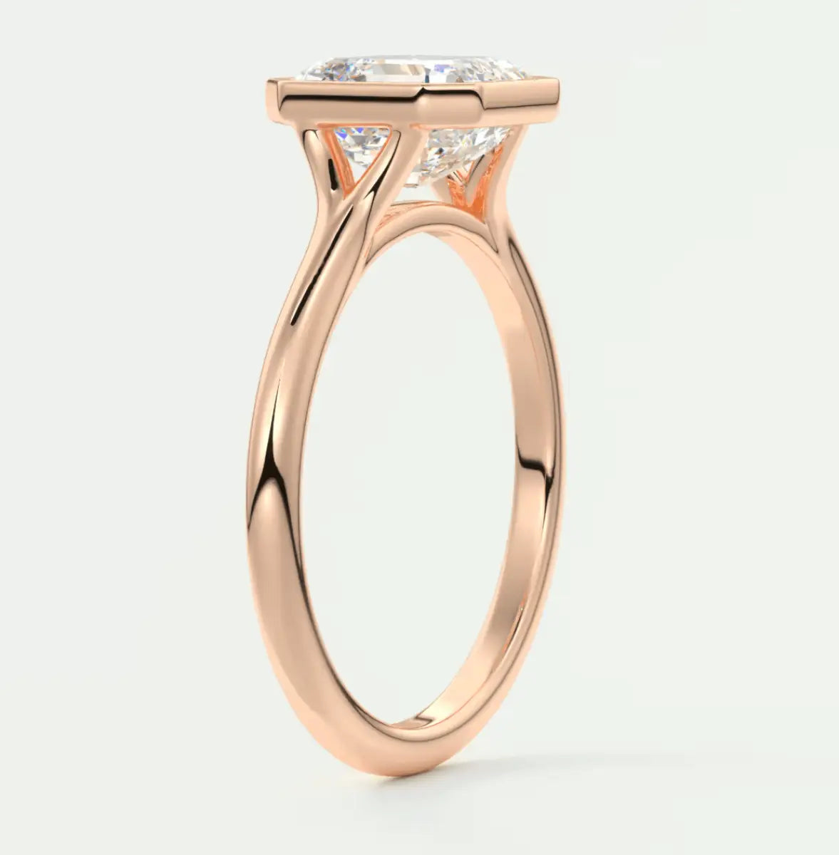 Rose gold diamond engagement ring with a cushion-cut center stone and prong setting.