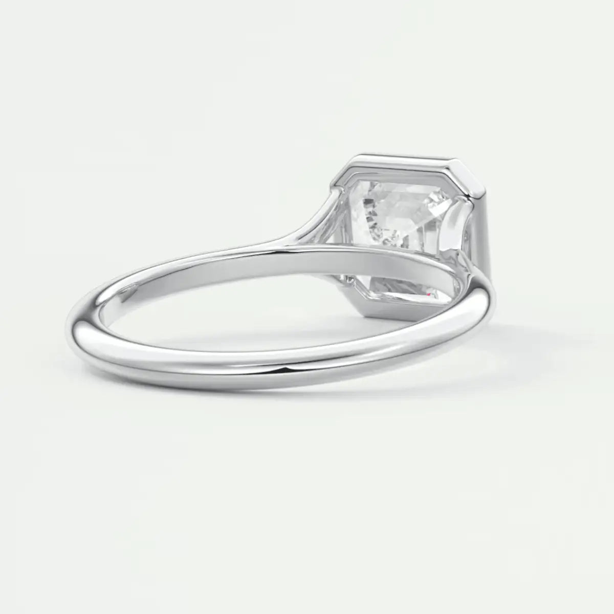 White gold solitaire engagement ring with a princess cut diamond.