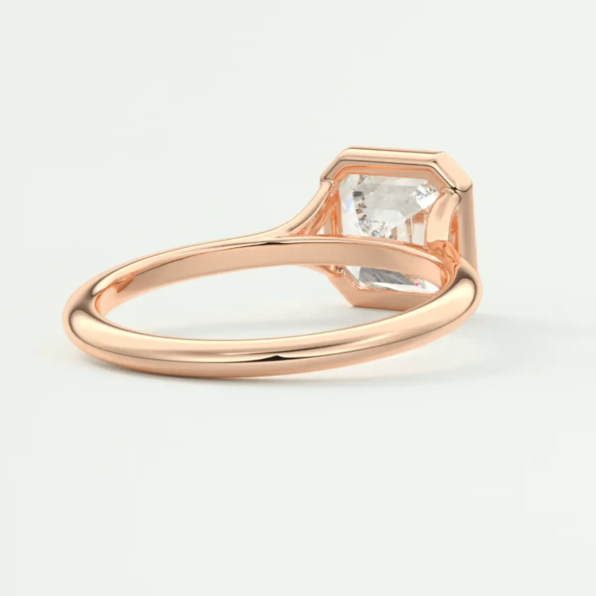 Rose gold engagement ring with a square-cut diamond.