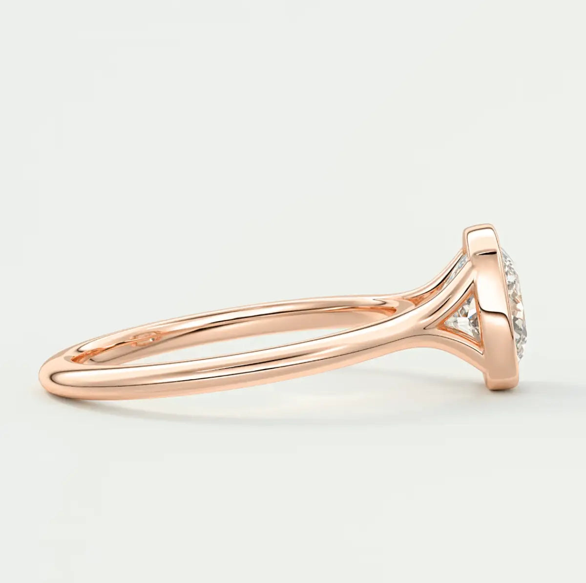 Rose gold diamond engagement ring with a halo design and prong setting