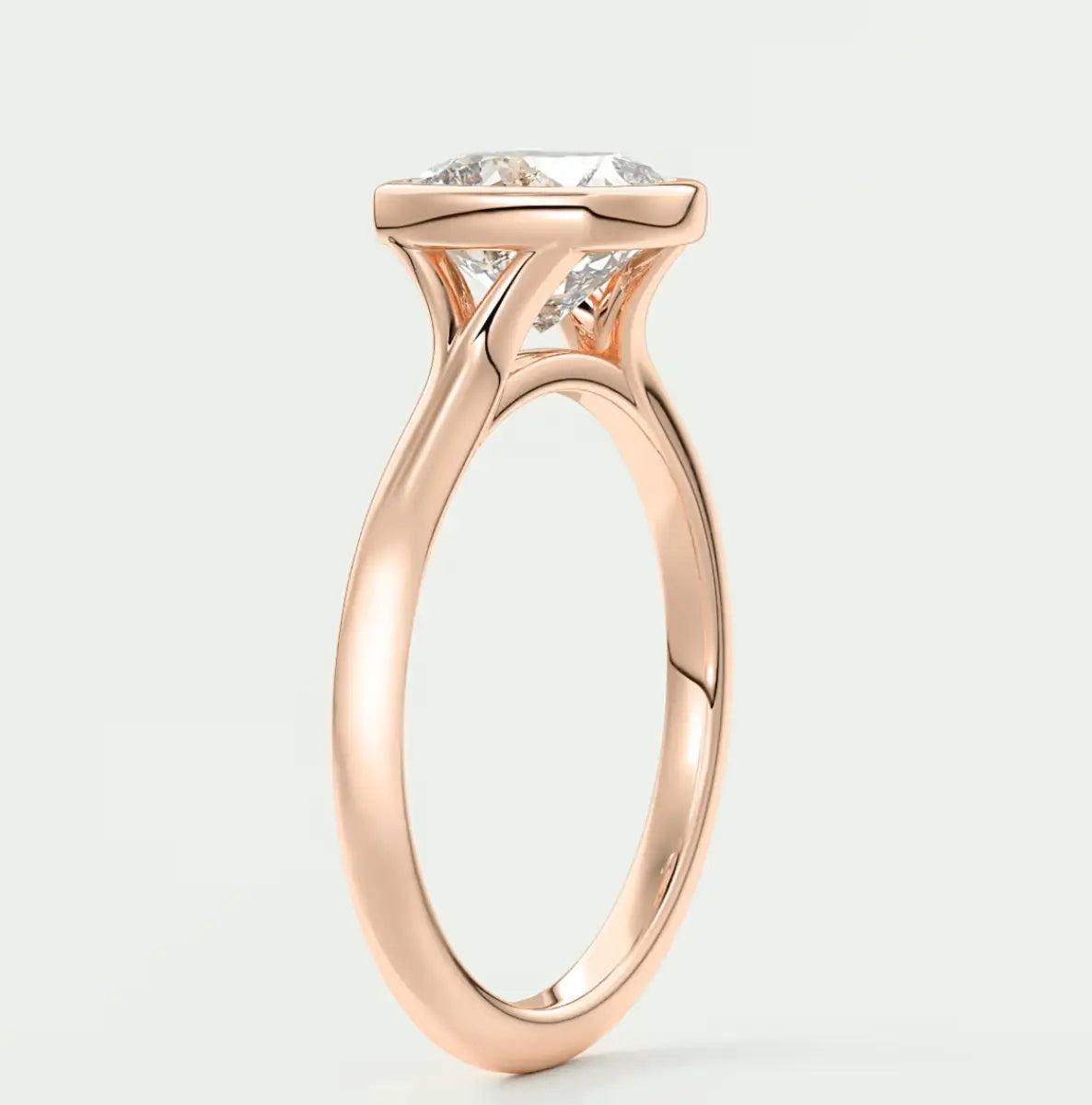 Rose gold engagement ring with a large, cushion-cut diamond and delicate band design.
