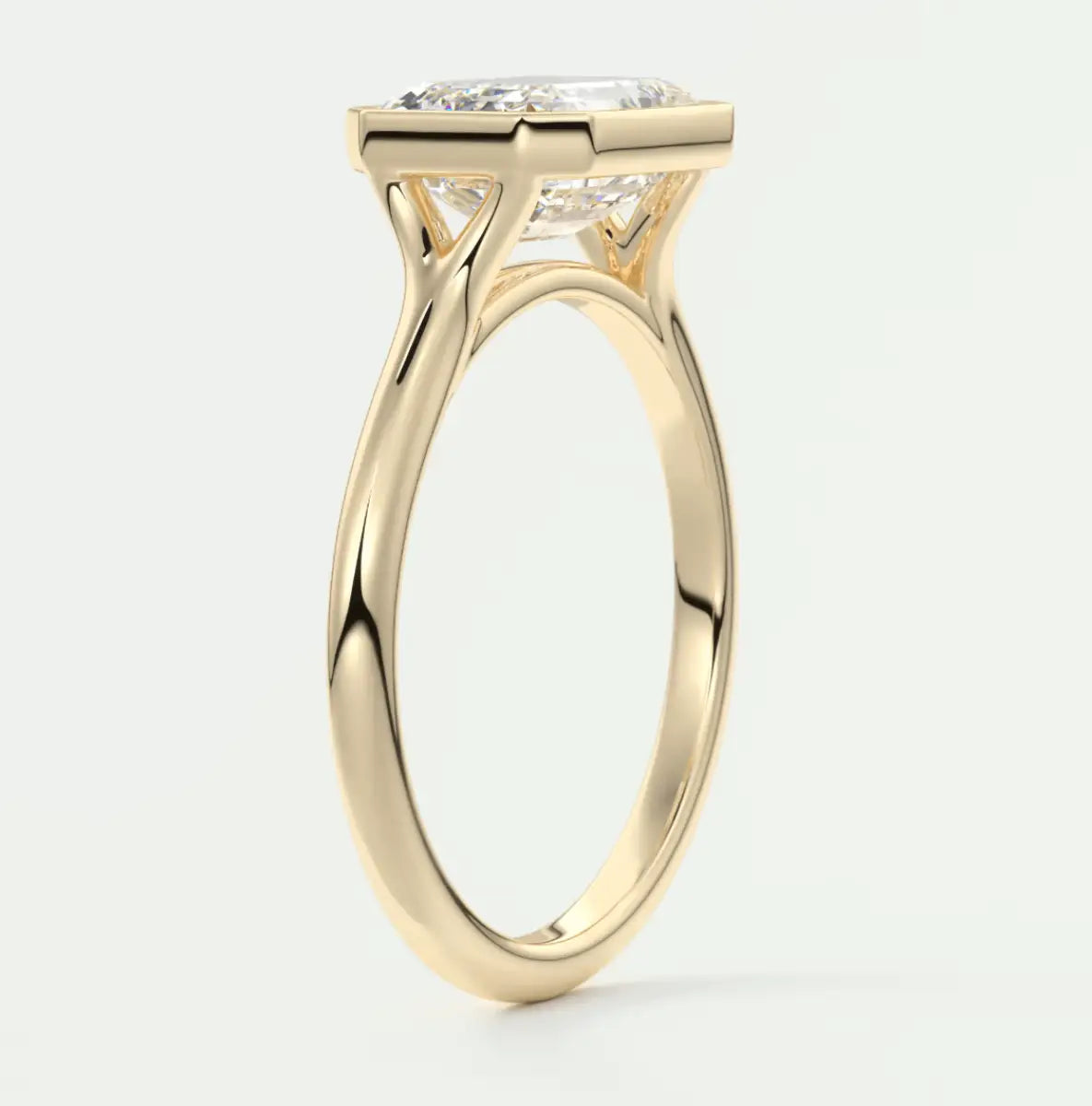 18-karat yellow gold engagement ring with a cushion-cut diamond.