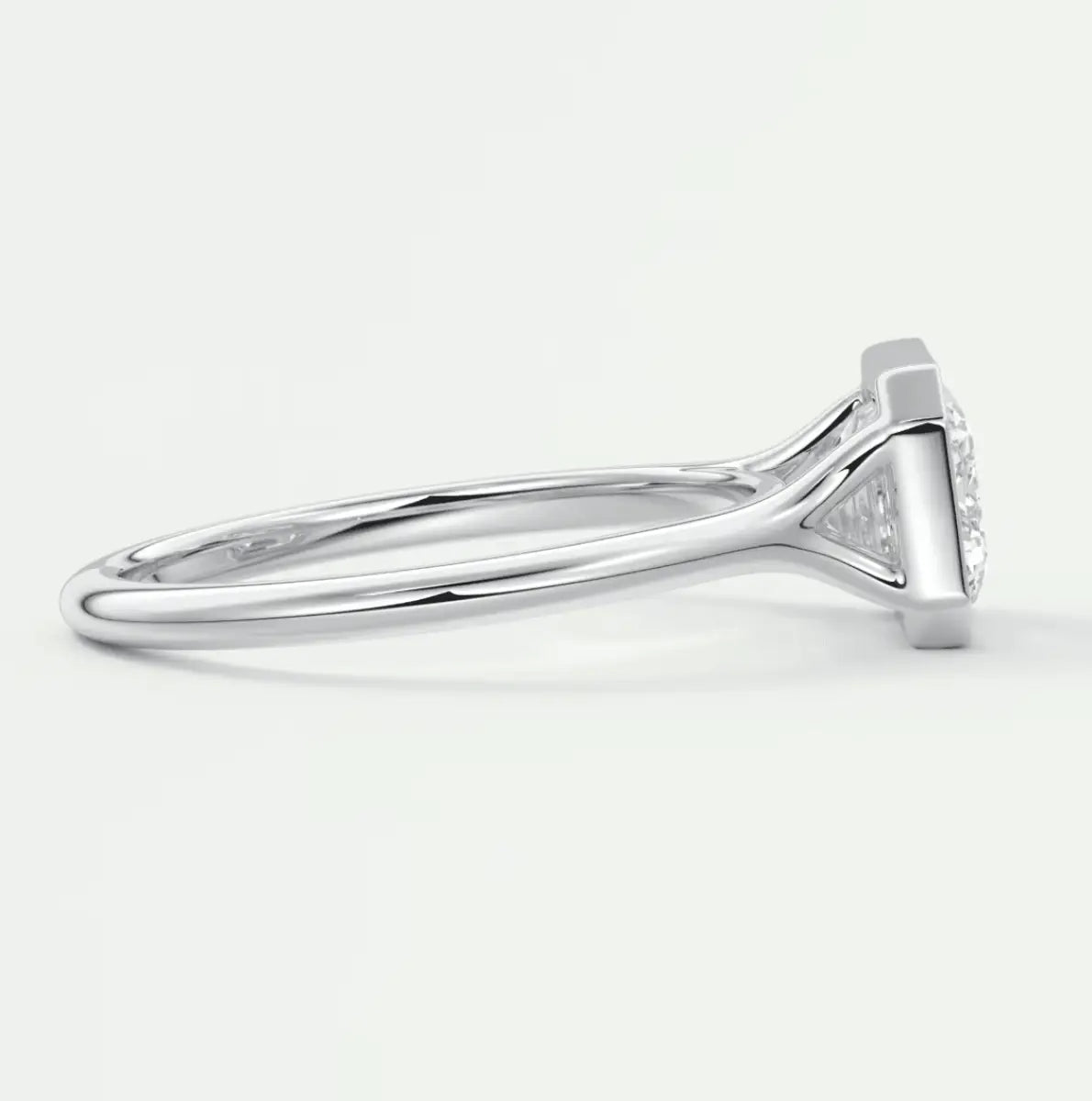 18k white gold diamond engagement ring with a marquise-cut center stone and small diamonds on the band.