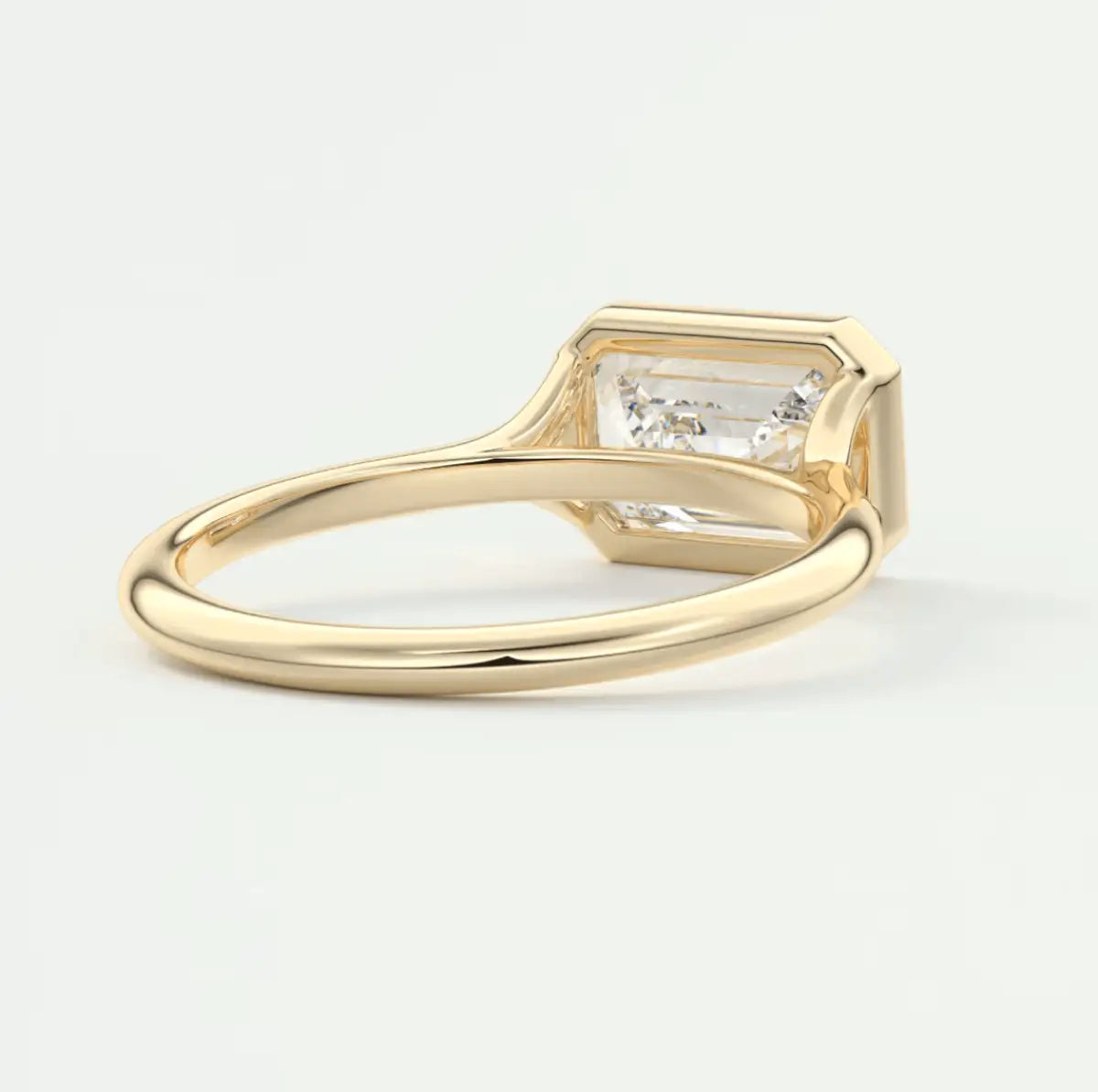 18k yellow gold emerald-cut diamond engagement ring.