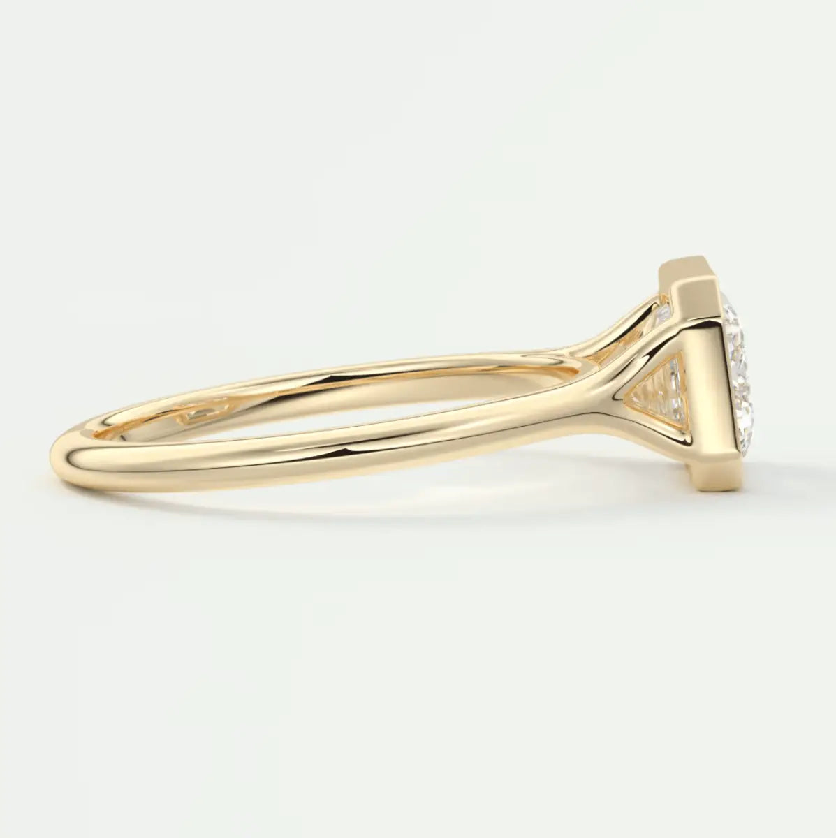 18k yellow gold engagement ring with a marquise-cut diamond and halo of smaller diamonds.
