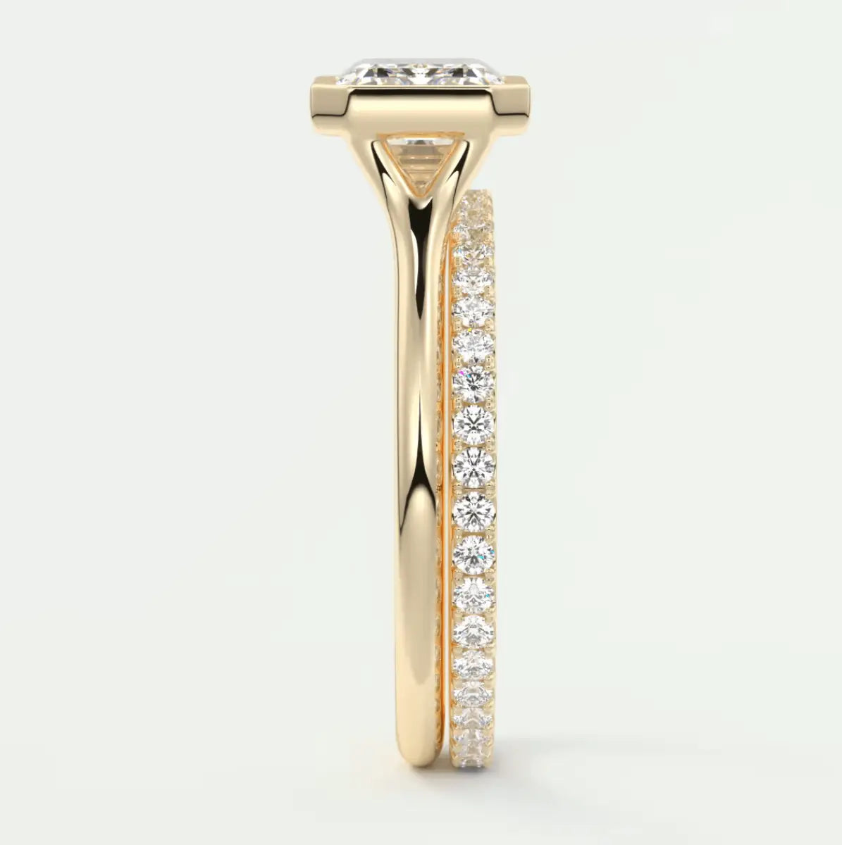 18k yellow gold engagement ring with a cushion-cut diamond and pave-set diamonds on the band.