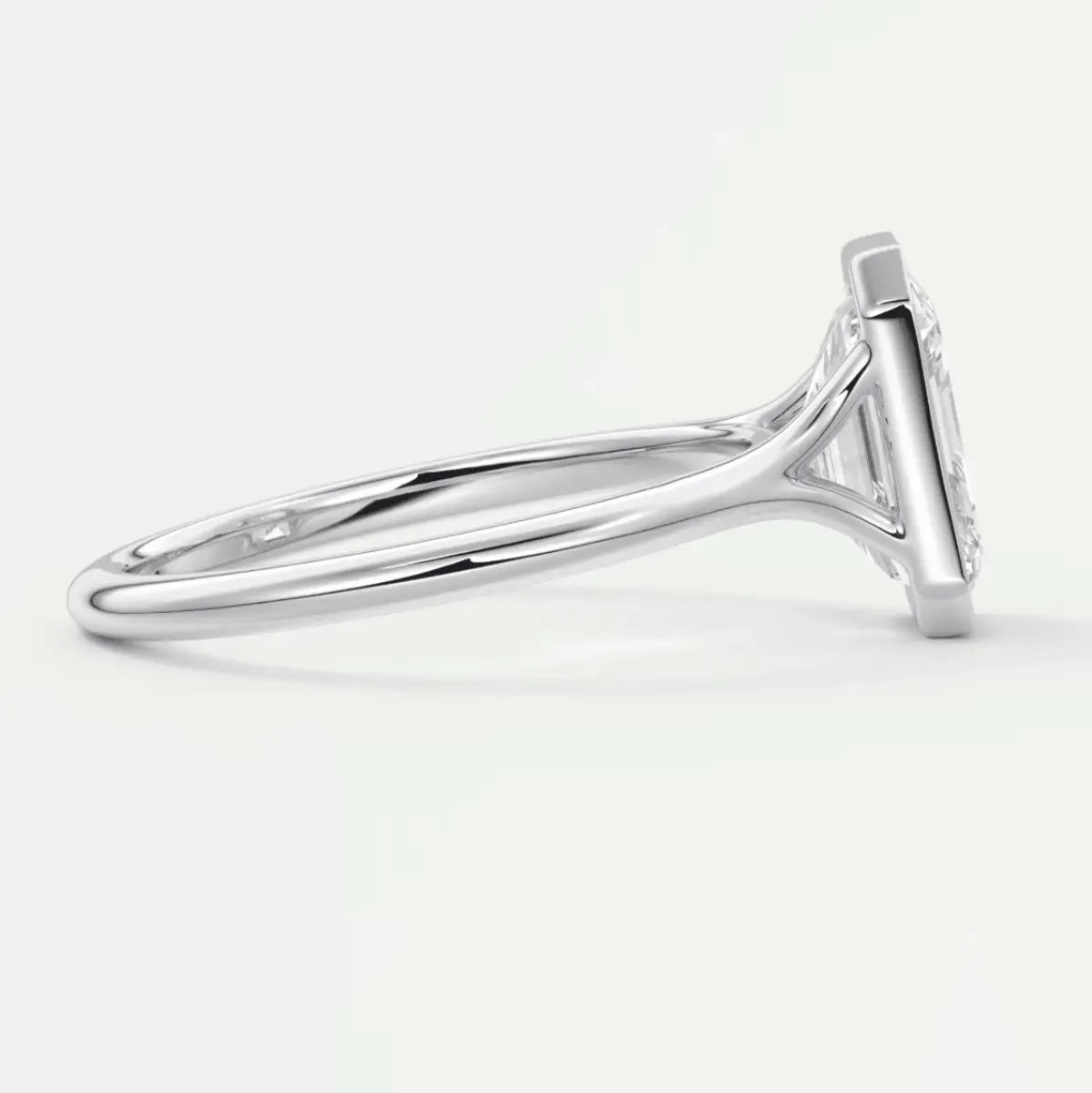 White gold diamond engagement ring with a princess cut center stone and side diamonds.