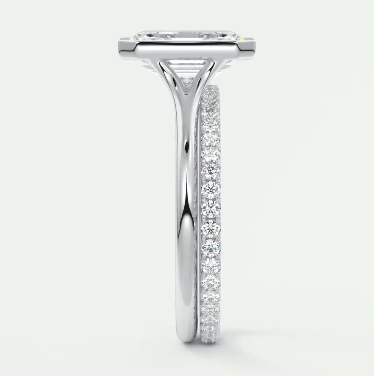 18-karat white gold diamond engagement ring with a princess-cut center stone and pavé set diamonds on the band.