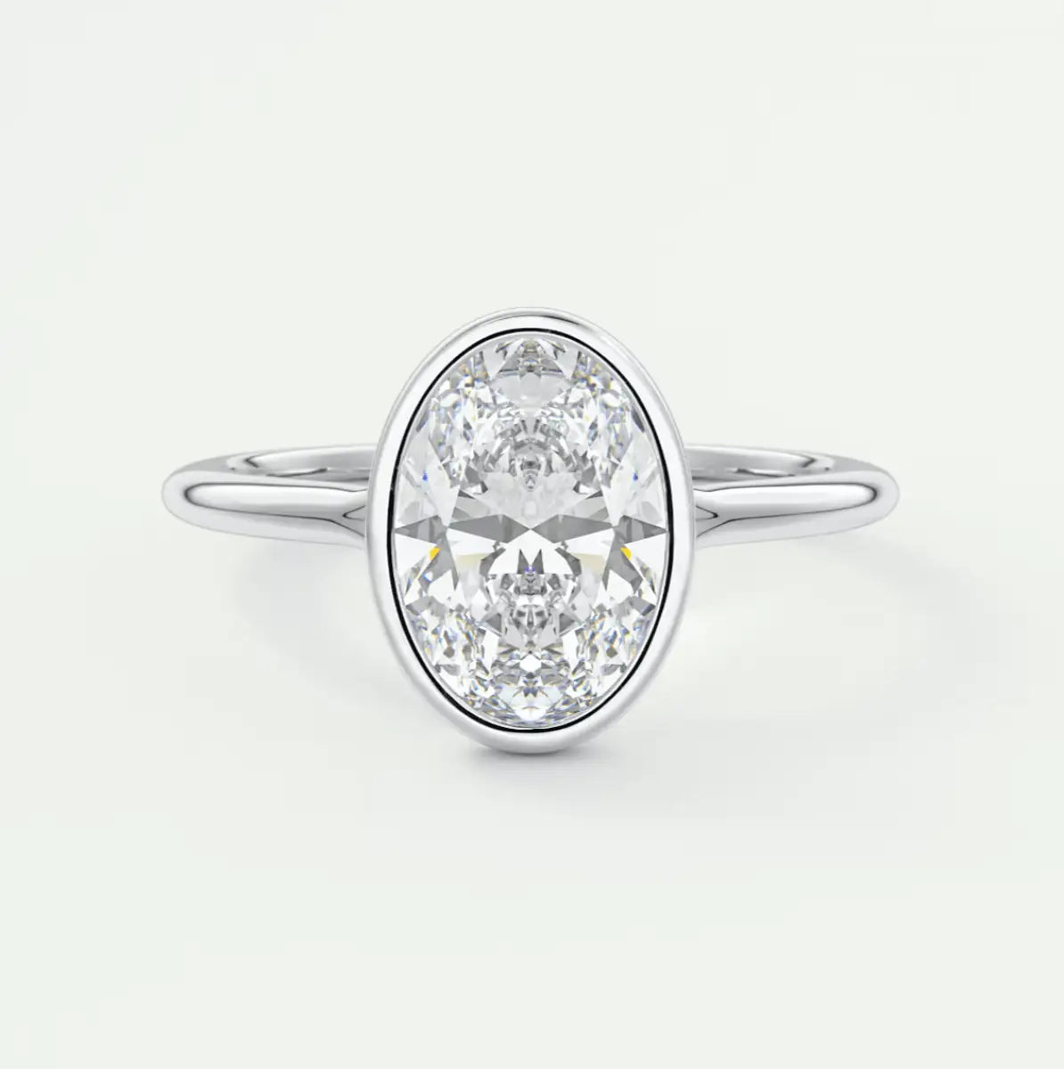 18k white gold diamond engagement ring with a bezel setting.
