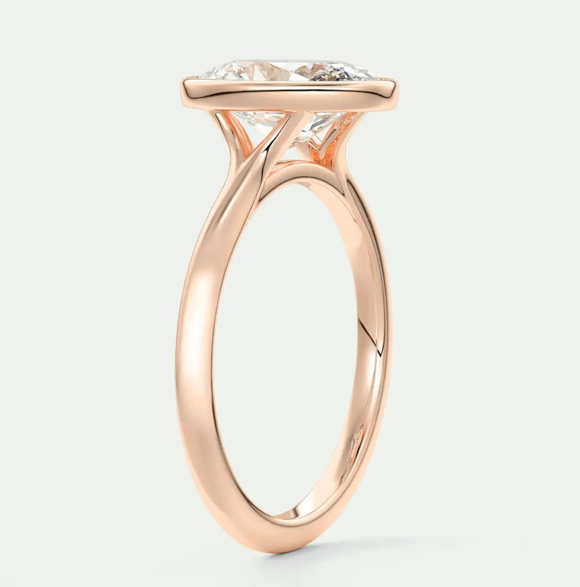Rose gold engagement ring with a large, cushion-cut diamond.