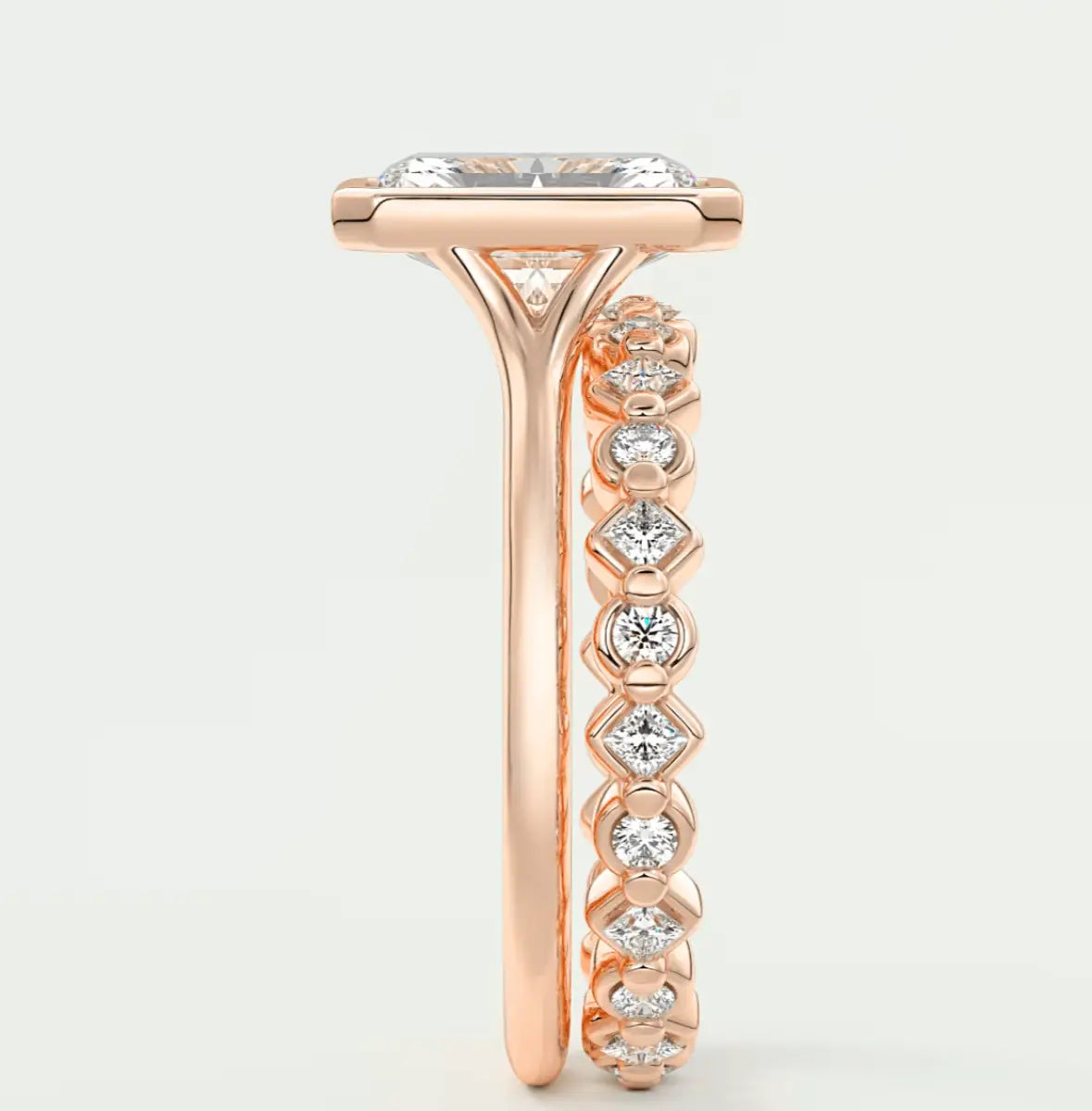 18-karat rose gold engagement ring with a princess-cut diamond center stone and pavé-set diamonds on the band.