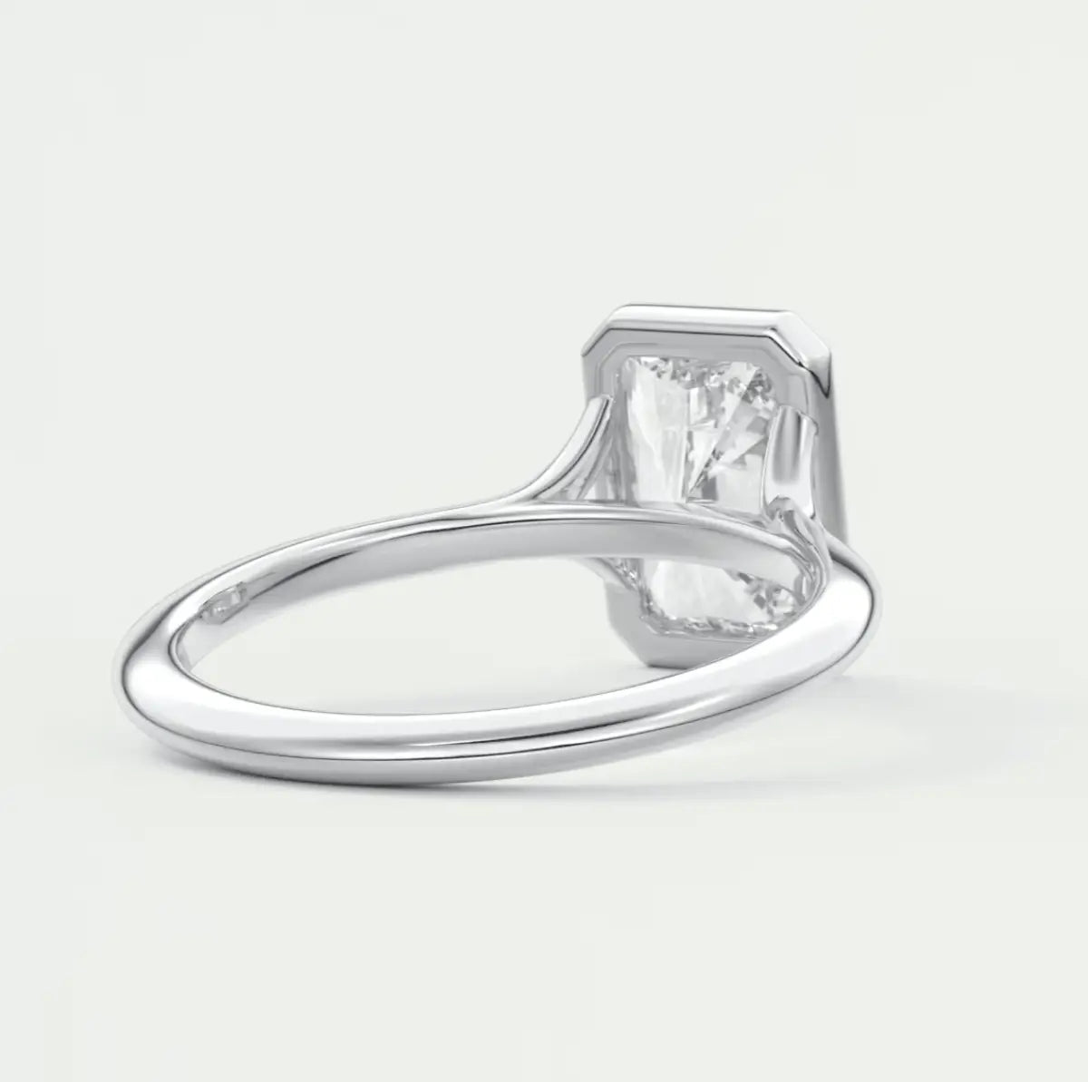 White diamond engagement ring with a square cut gem and milgrain detailing on the band.
