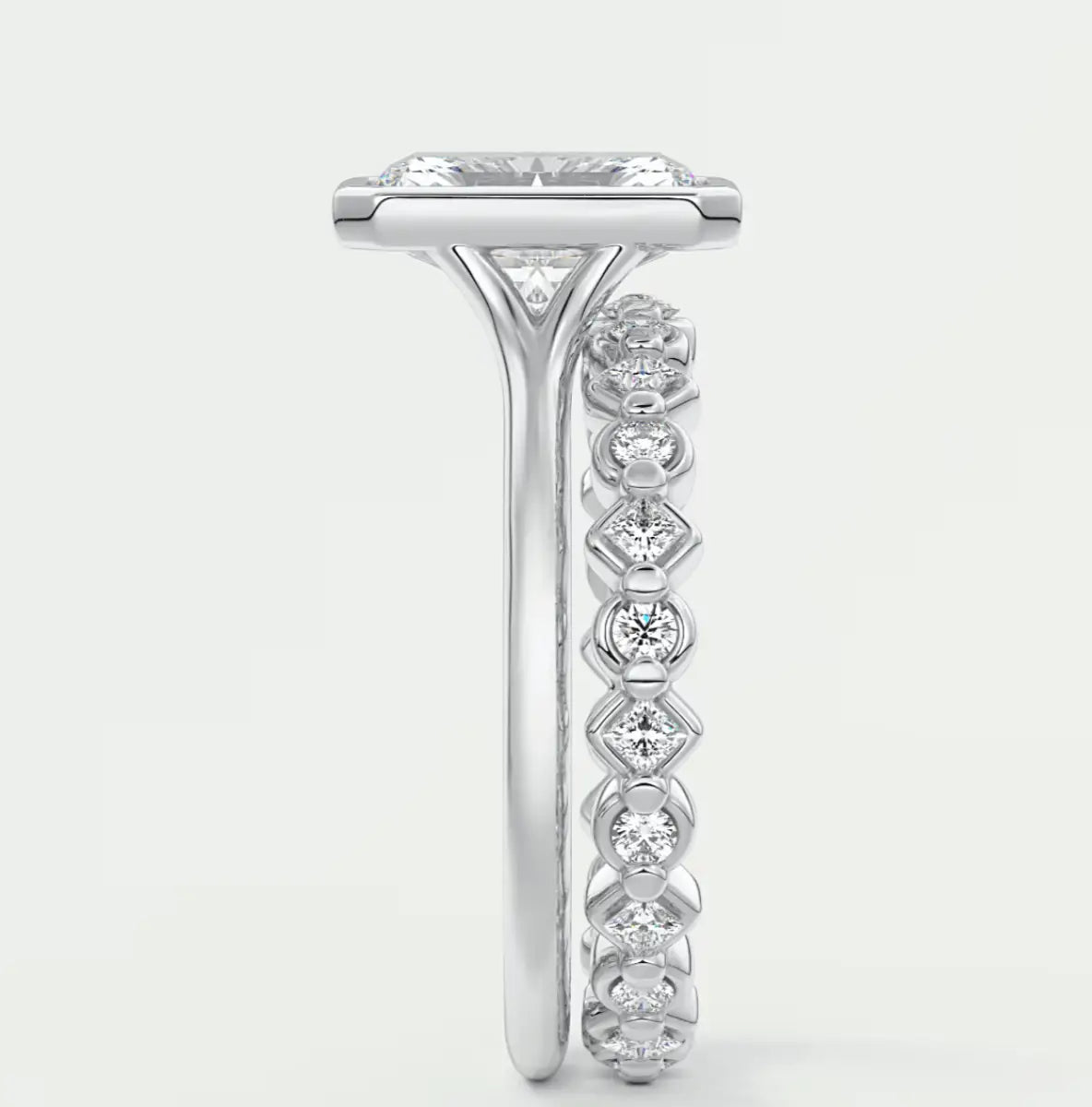 18k white gold diamond engagement ring with a princess cut center stone and pavé set diamonds on the band.