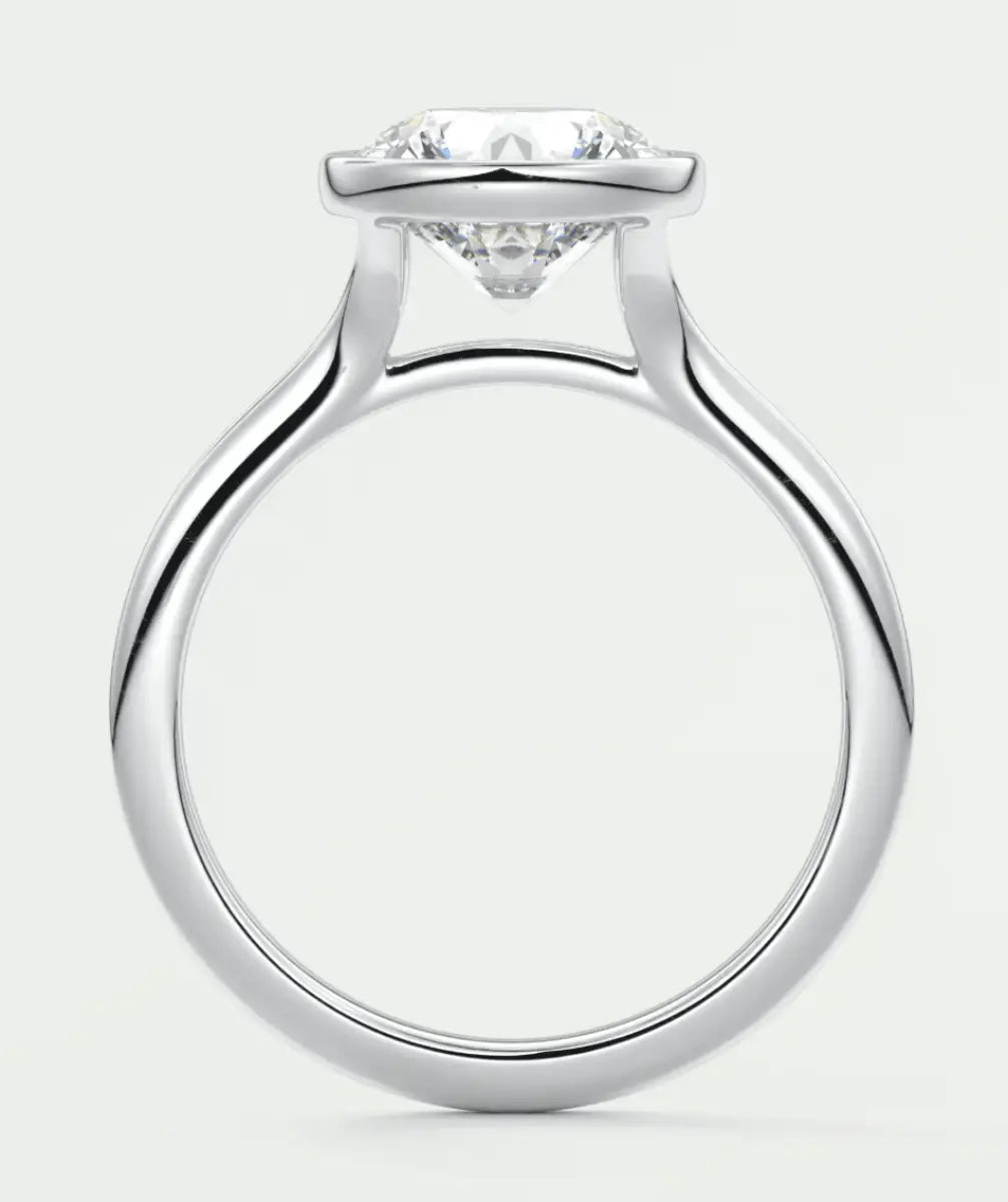 White gold solitaire diamond engagement ring with a round brilliant cut stone.