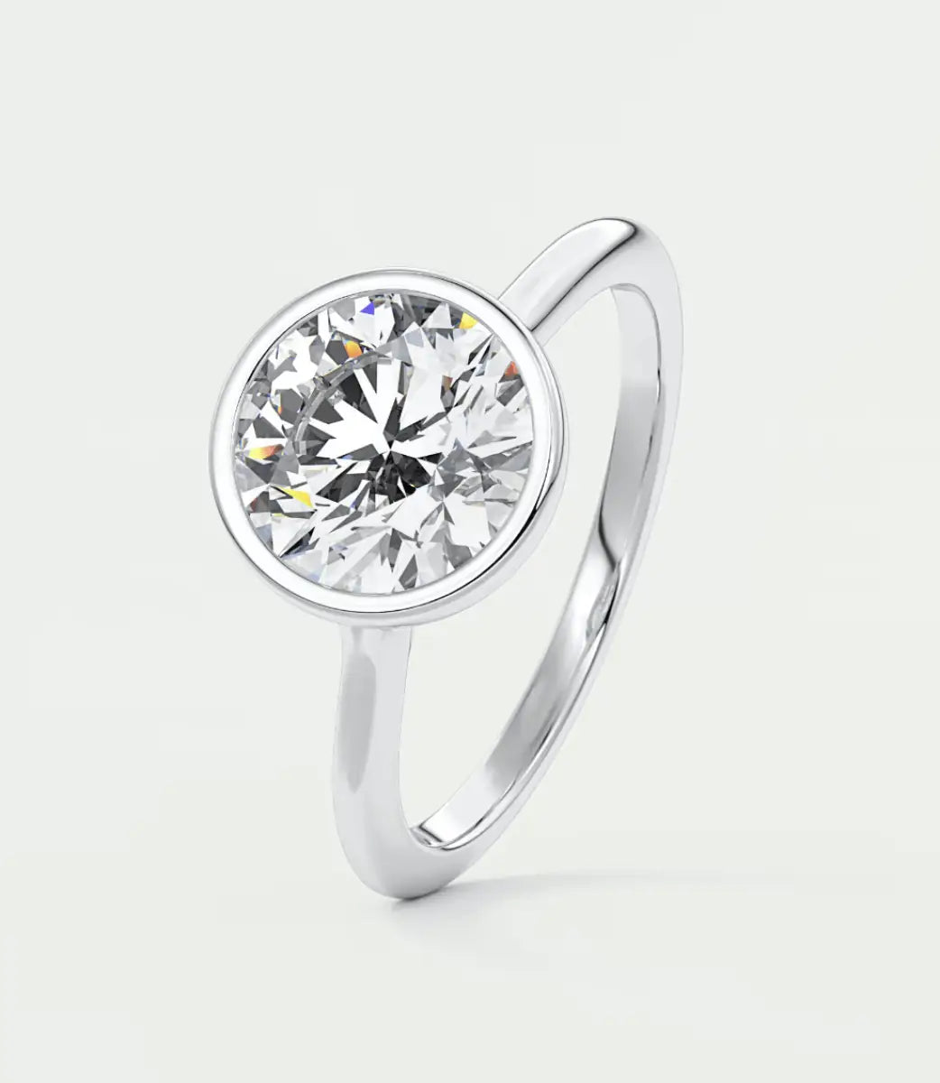 18k white gold solitaire diamond engagement ring with a round brilliant cut gem.