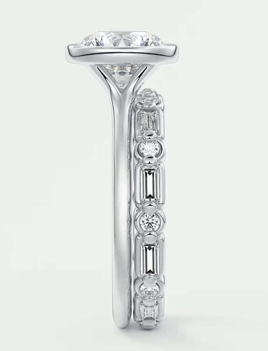 18-karat white gold diamond engagement ring with a central cushion-cut stone and baguette side stones.
