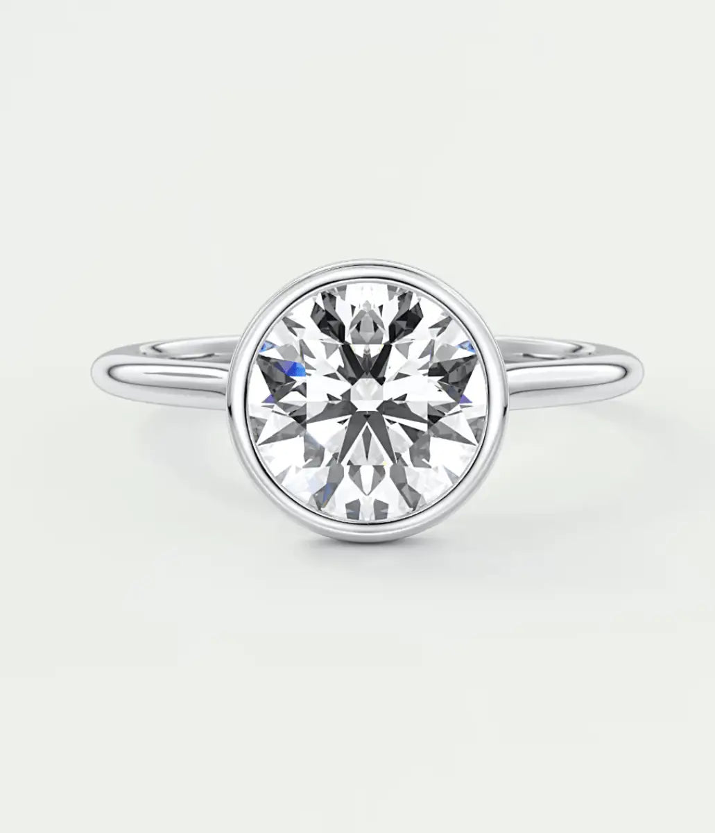 18-karat white gold solitaire diamond engagement ring with a round-cut center stone.