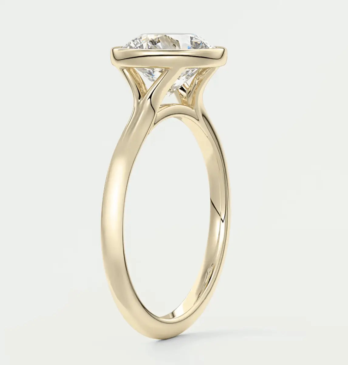 18-karat yellow gold solitaire engagement ring with a round diamond.