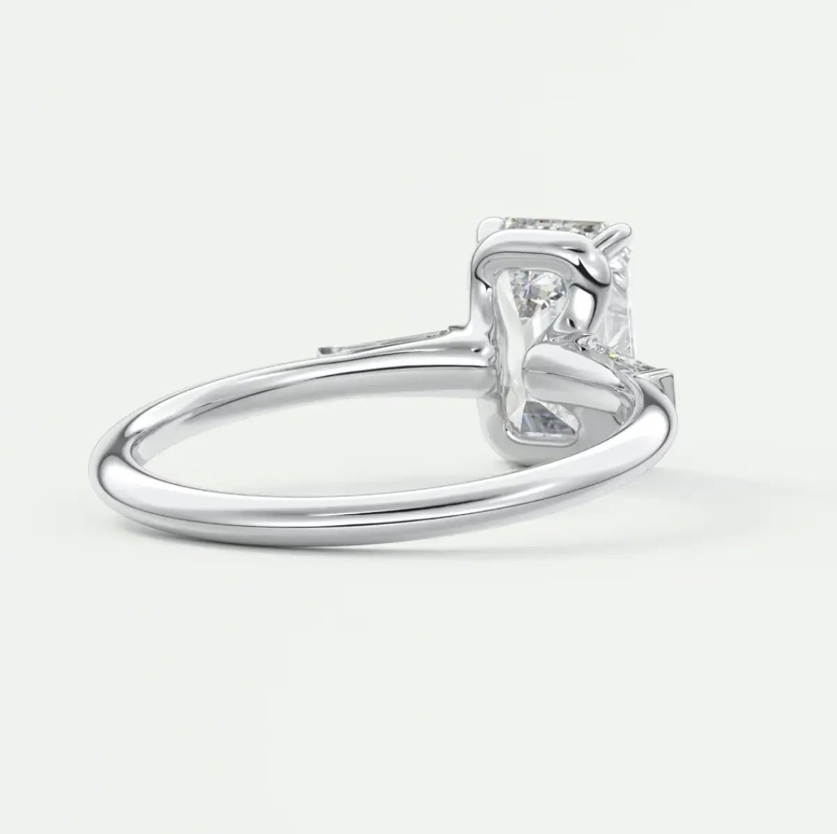 Custom made elysian emerald three-stone engagement ring with tapered baguettes
