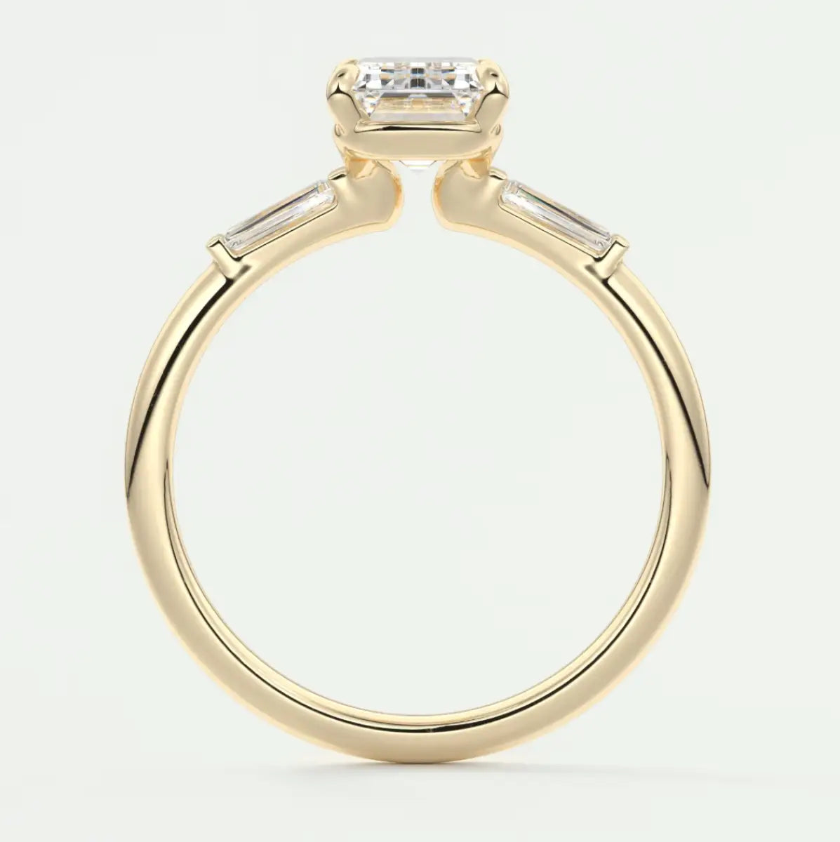 Custom made elysian emerald three-stone engagement ring with tapered baguettes
