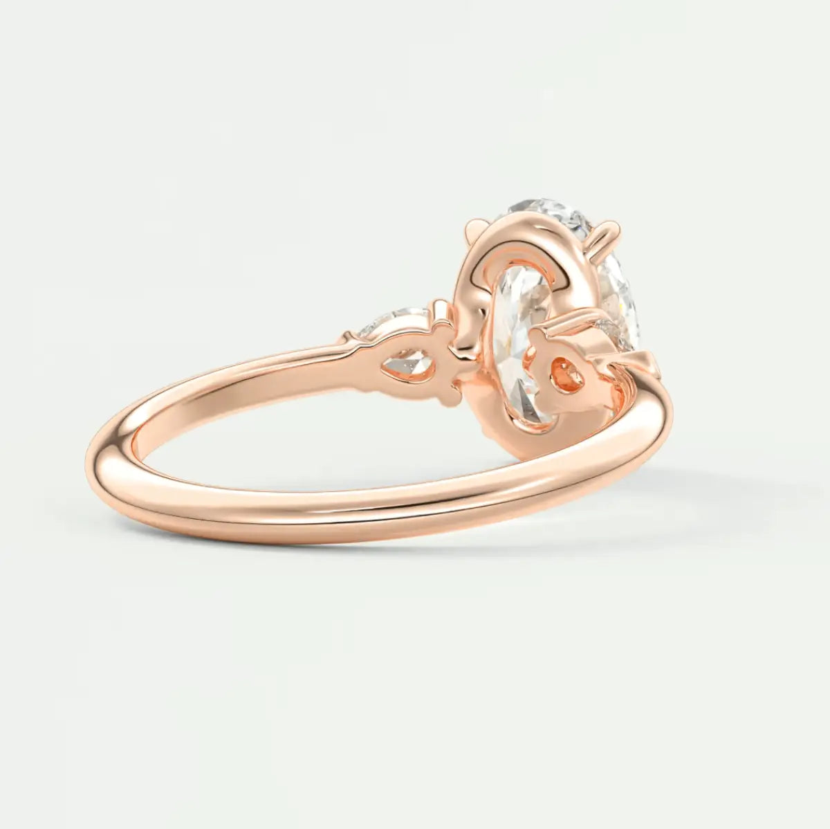 Rose gold diamond engagement ring with a heart-shaped design and three prongs.