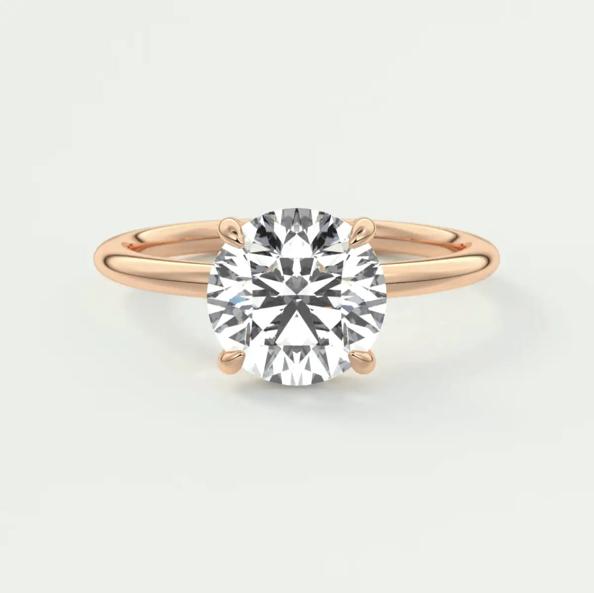 18k rose gold engagement ring with a cushion-cut diamond.