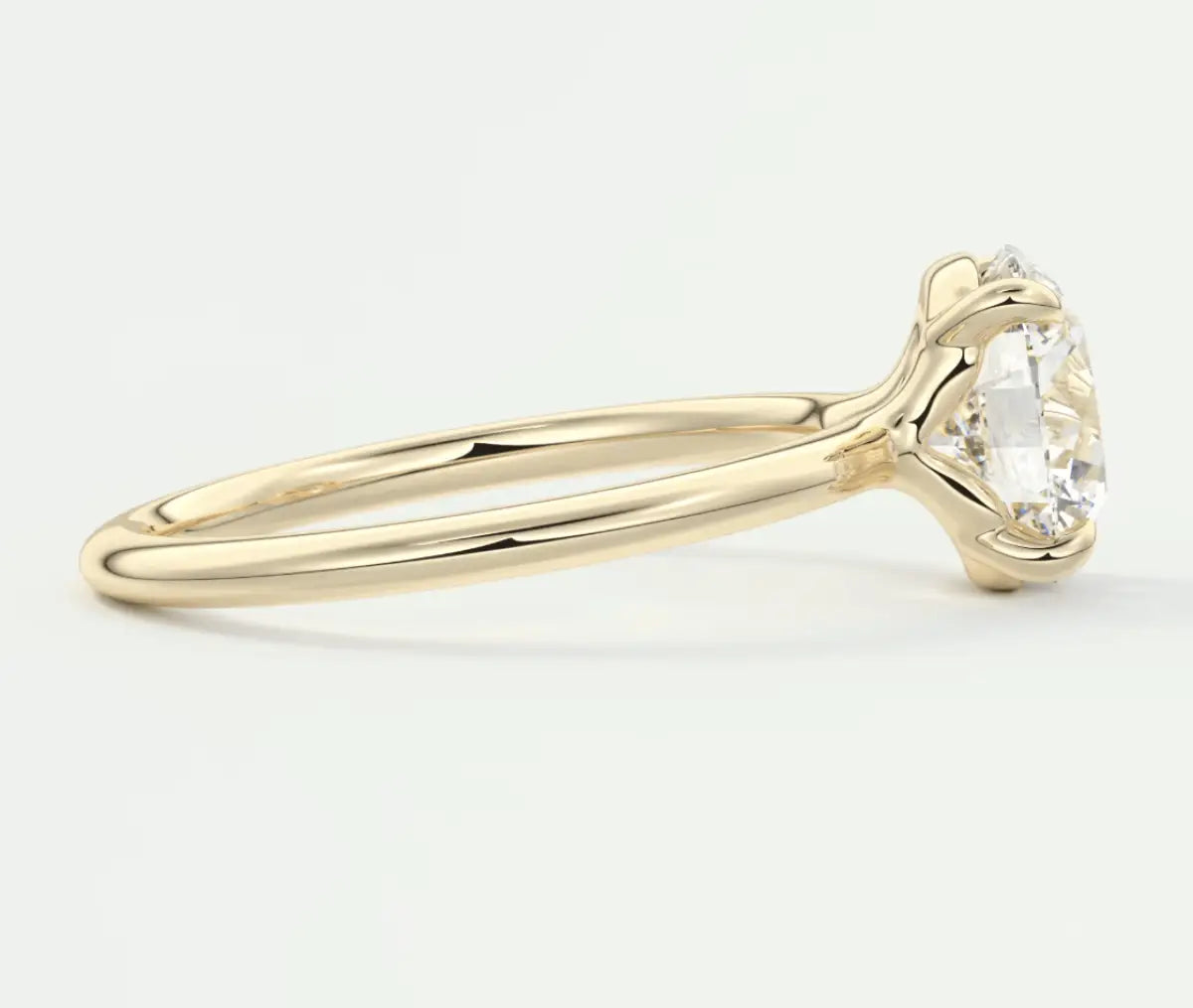 18k yellow gold engagement ring with a round diamond.