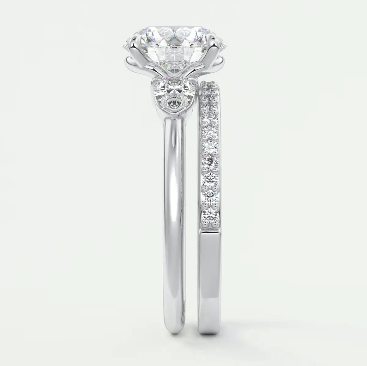 Custom made elysian round three-stone engagement ring with pear side stones | diamond lab