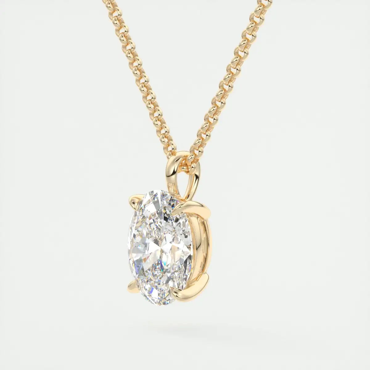 Gold necklace with a diamond pendant on a light gray background