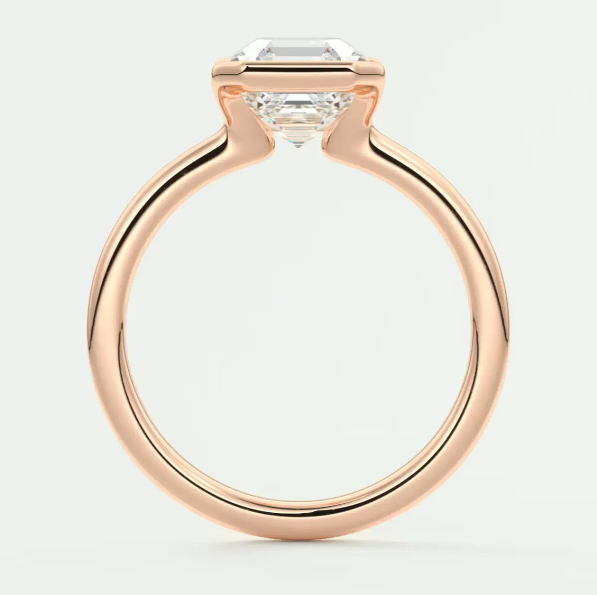 Rose gold engagement ring with emerald cut diamond.