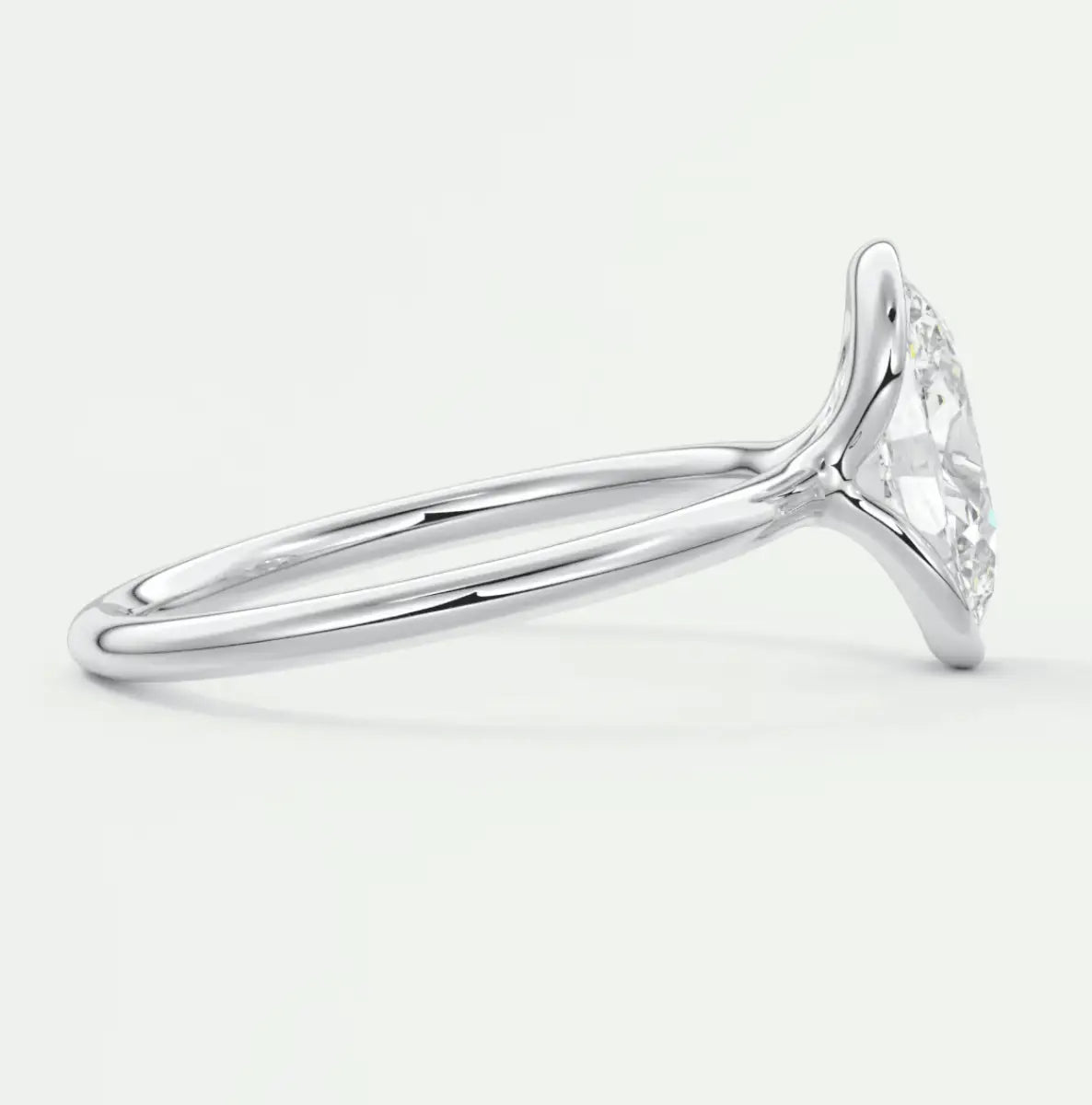 White gold diamond engagement ring with a marquise-cut center stone and intricate halo design.