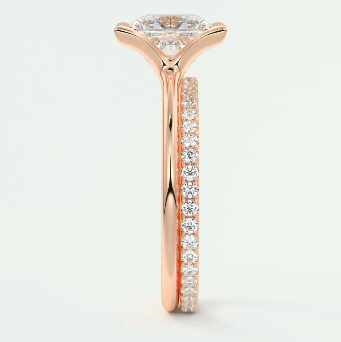 18k rose gold diamond engagement ring with a round brilliant cut center stone and pave set diamonds on the band.